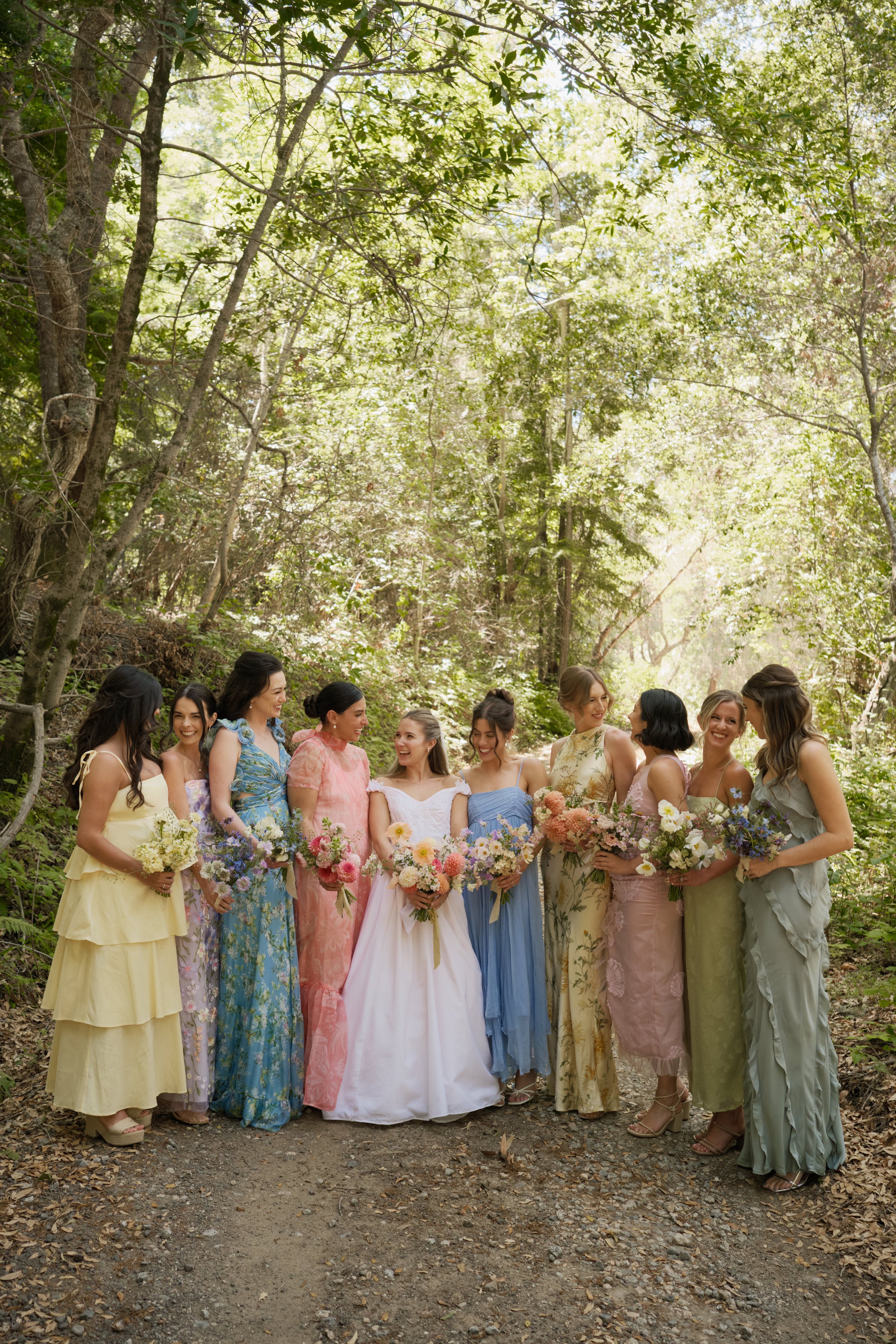 bride with her bridesmaids and all colorful bouquets