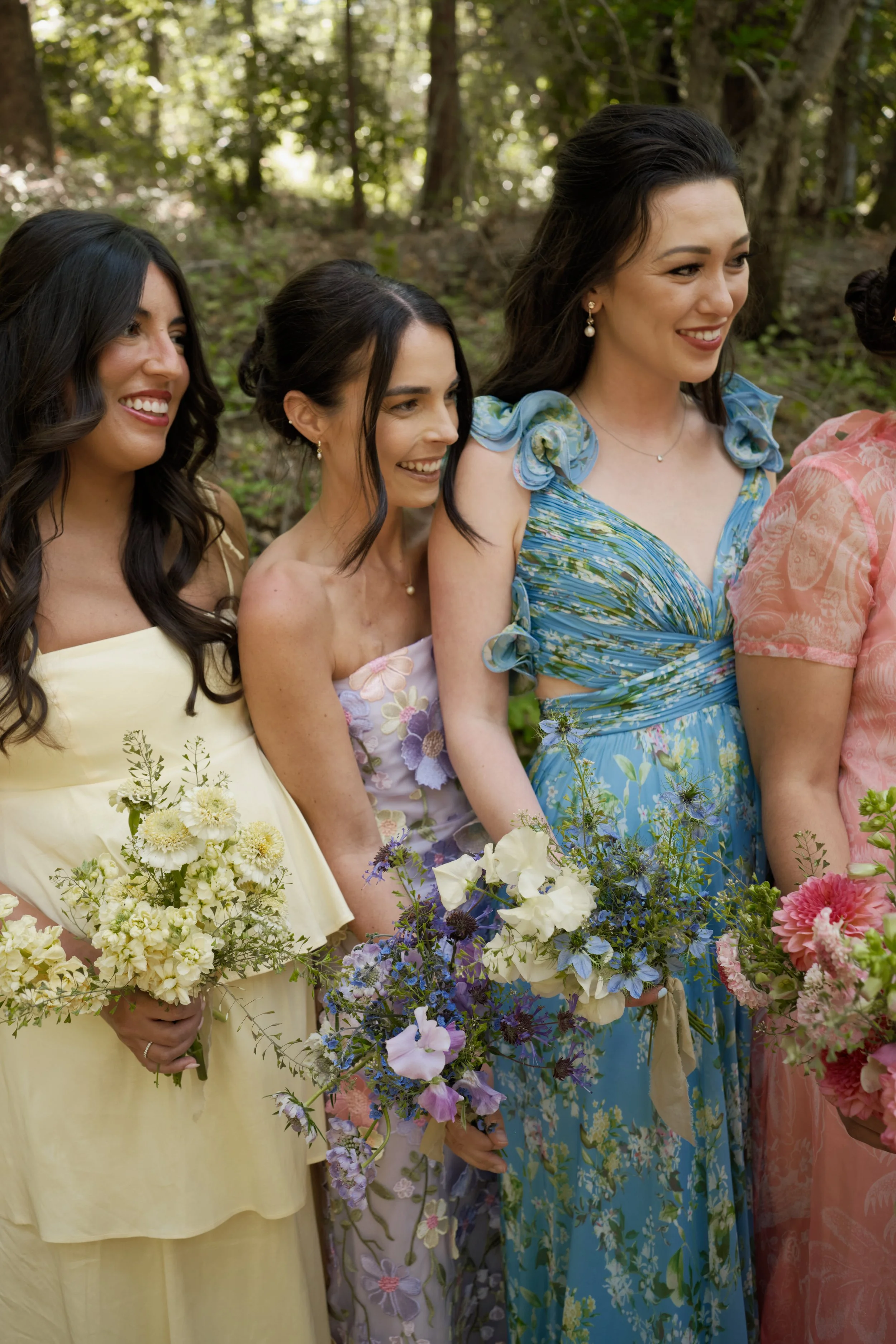 bridesmaids in different dresses with matching bouquets