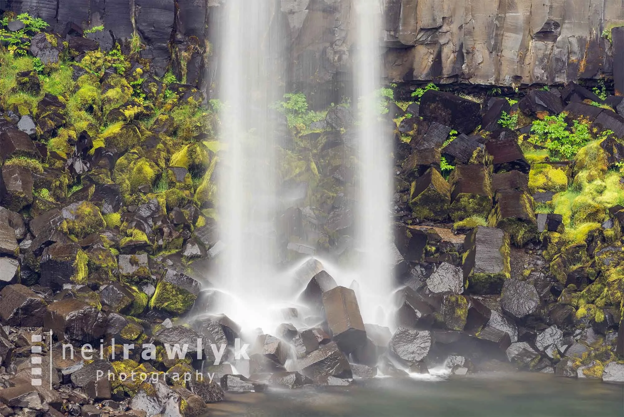 Broken lava columns beneath Svartifoss waterfall Iceland