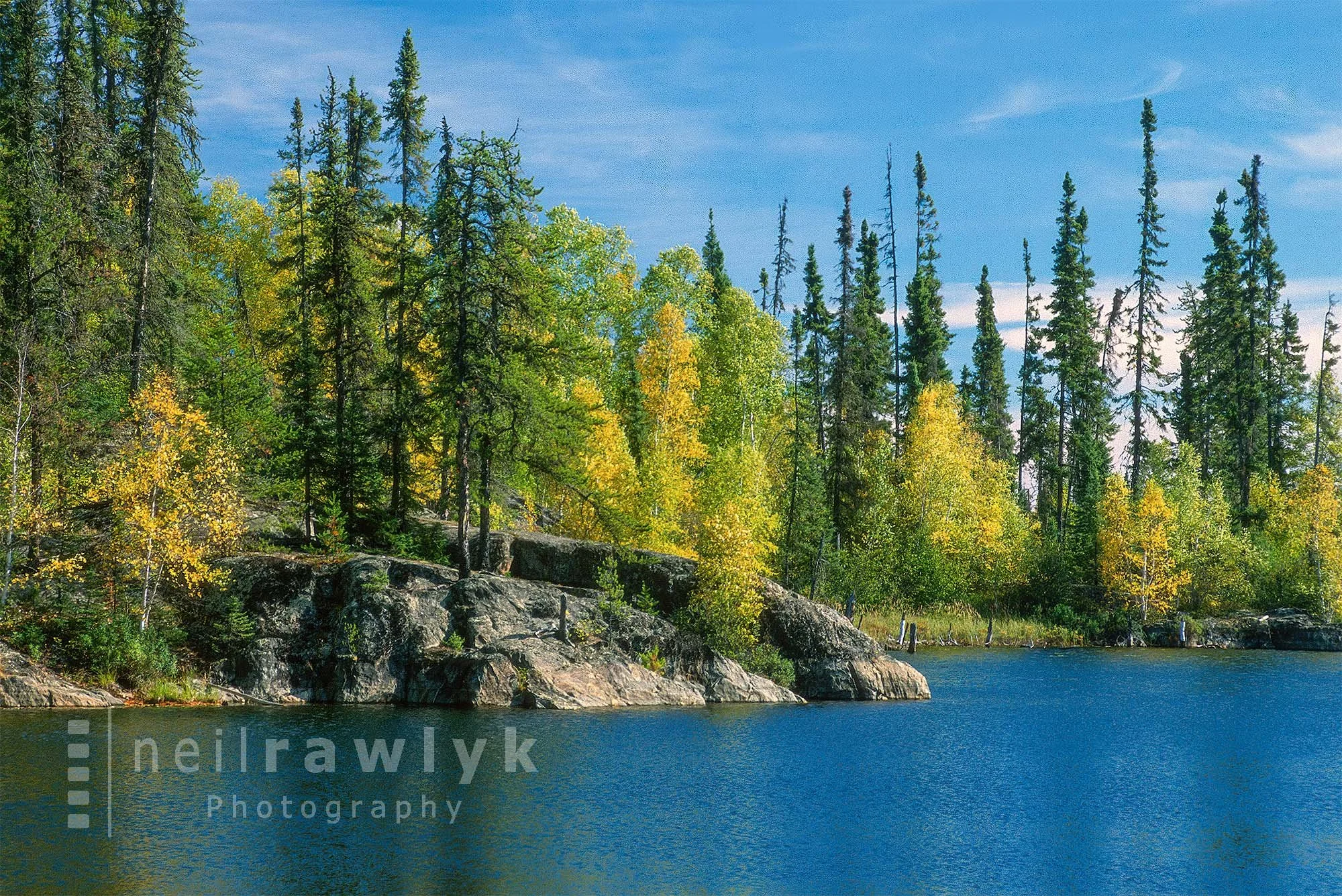 Colourful trees along a rocky shore at Dicken's Lake