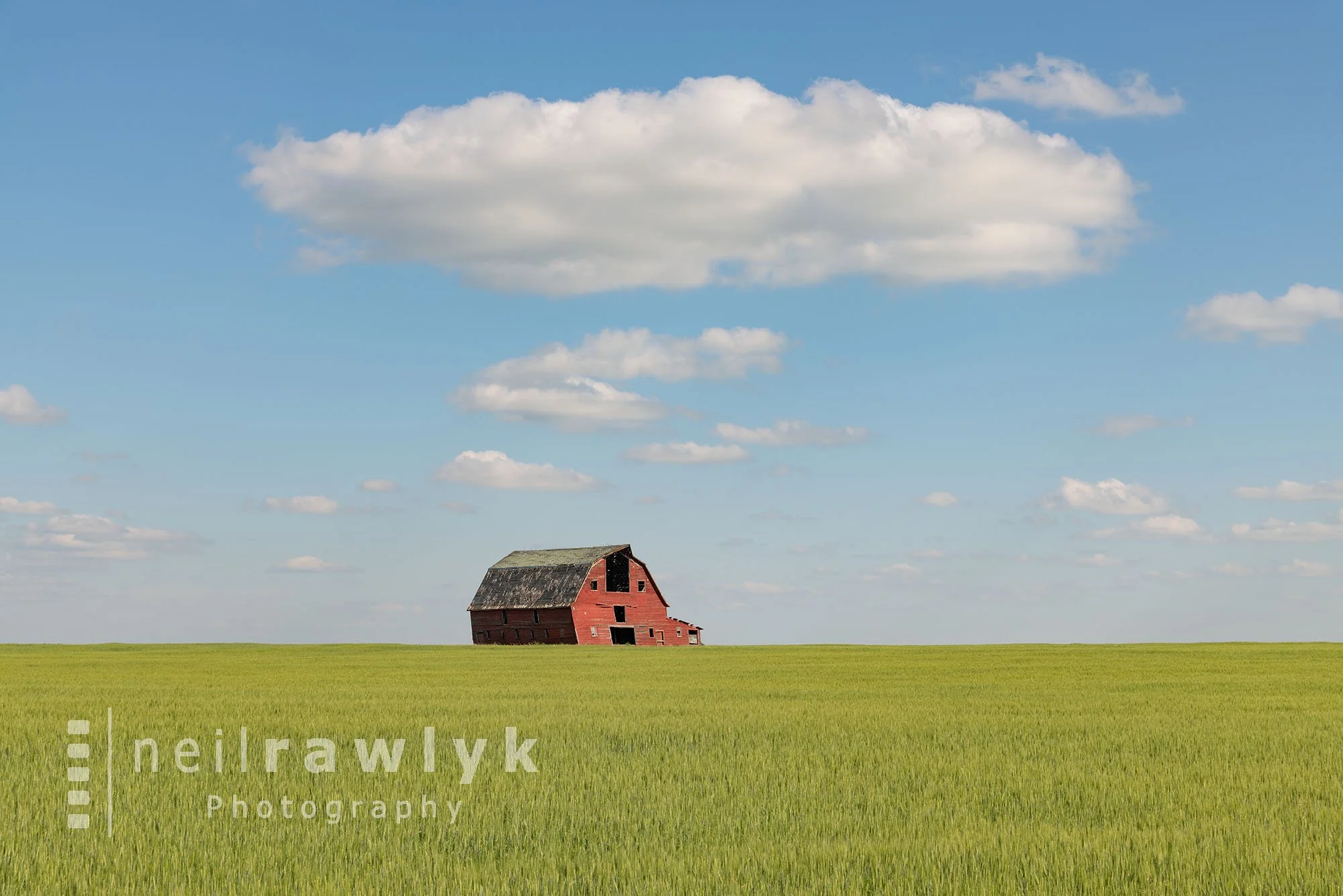An Old Red Barn in a Green Field