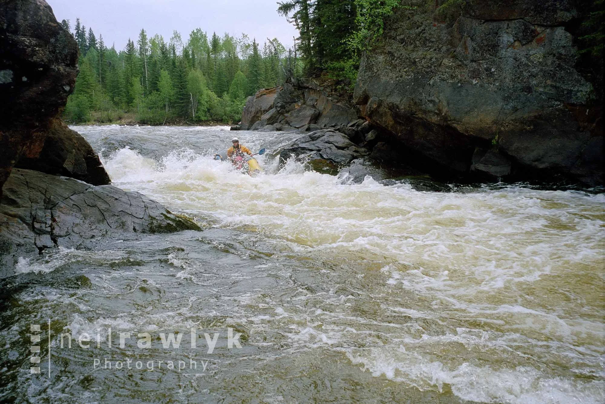 A river raft going over rapids
