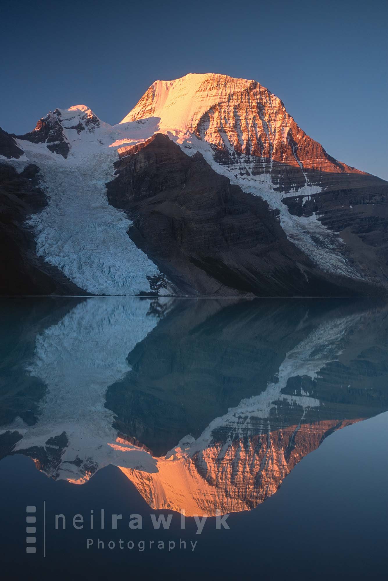 Mount Robson at sunrise reflected in Berg Lake