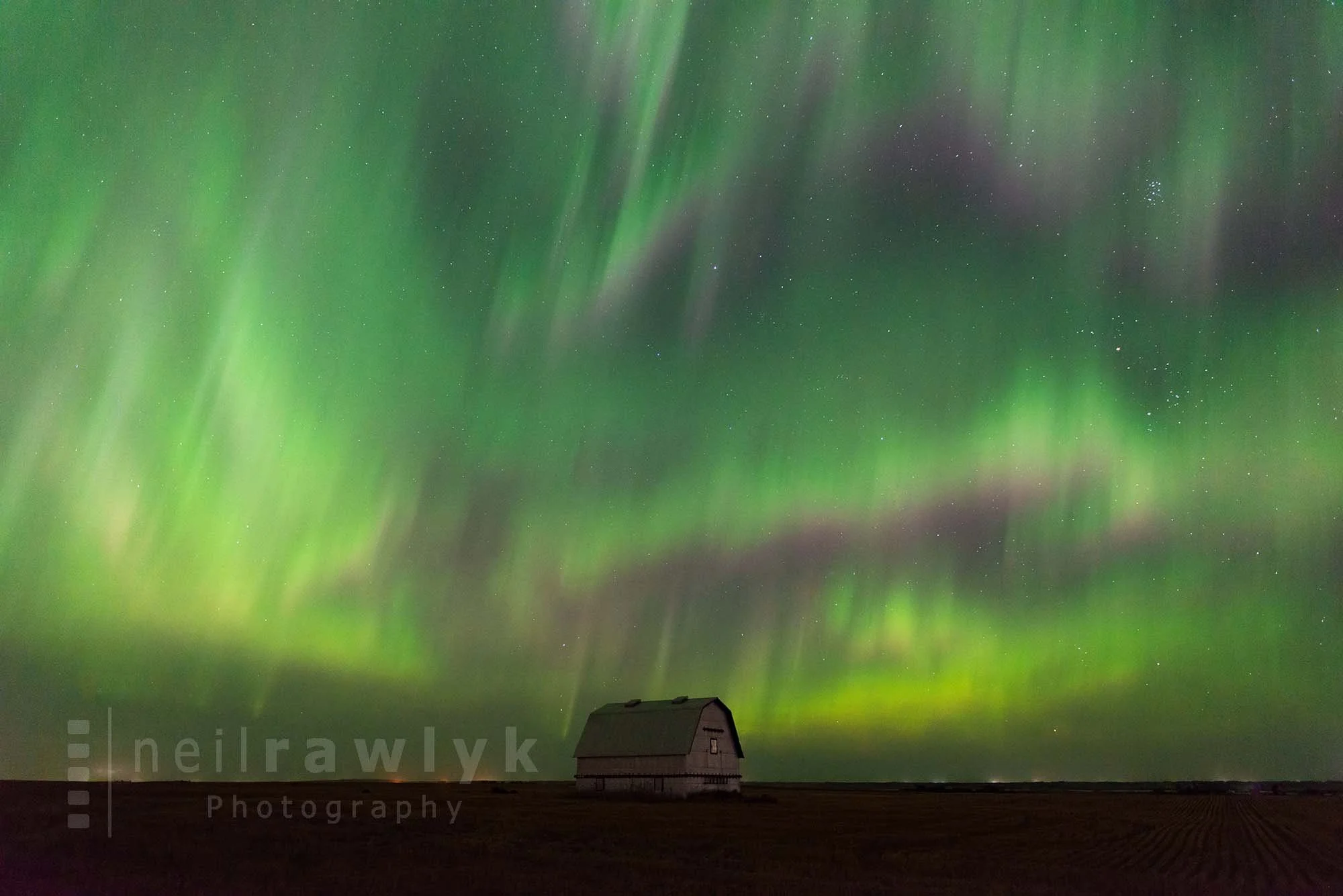 Northern lights over an old barn