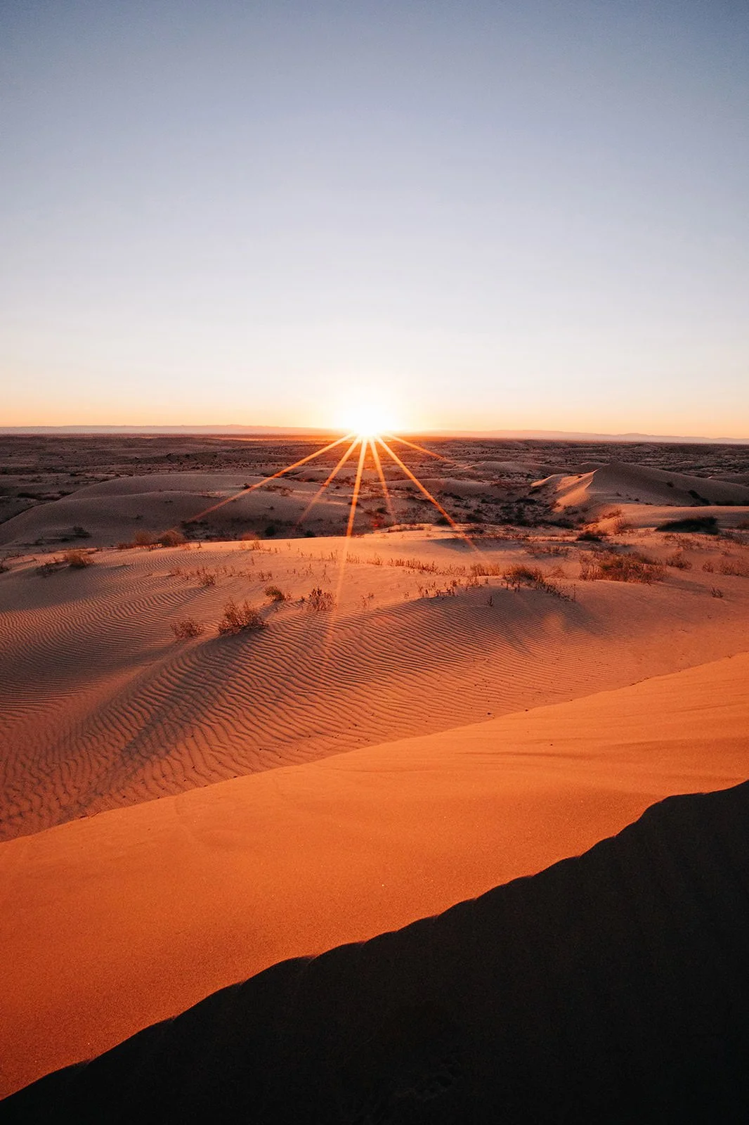 The sun setting over the desert.
