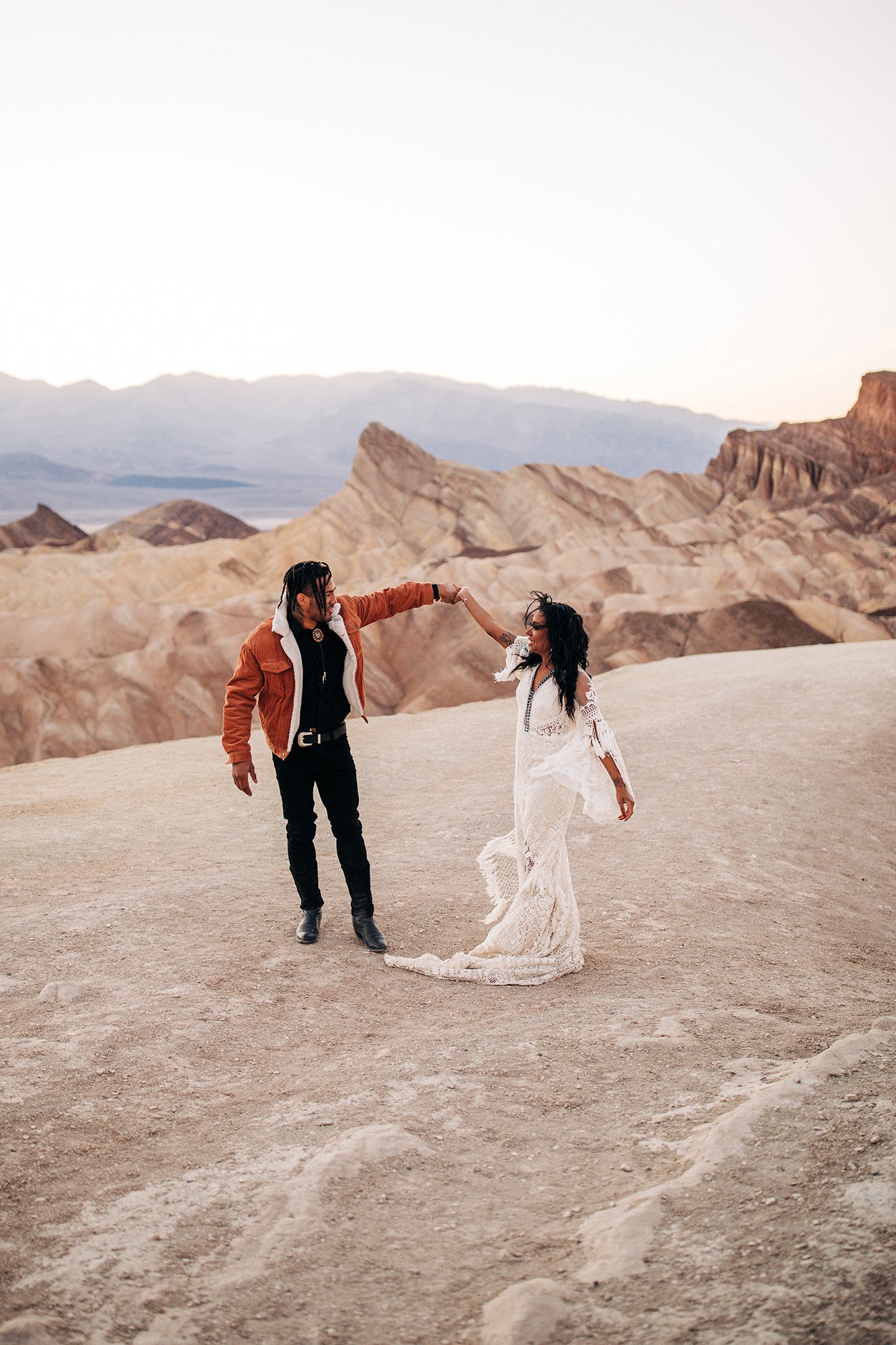 Mieko and Kevin dance in front of an iconic view in Death Valley National Park.
