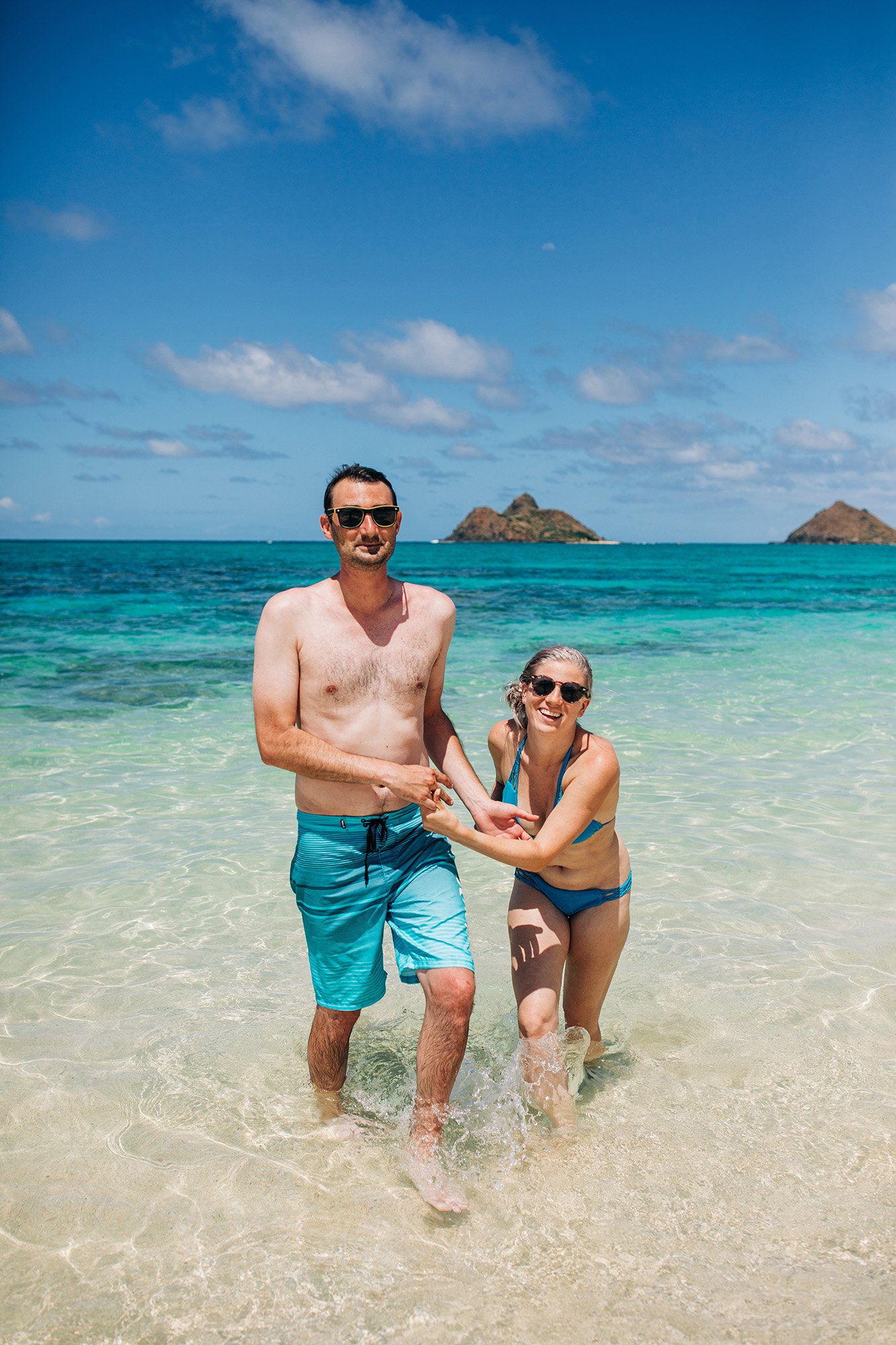 Ruta and Greg wades through the blue waters of Oahu, Hawaii.