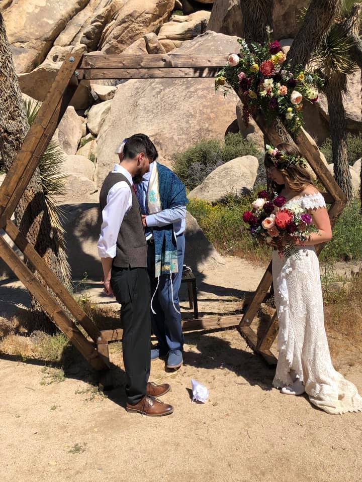 Diana and Isiah stand under the chuppah during their Jewish elopement. 