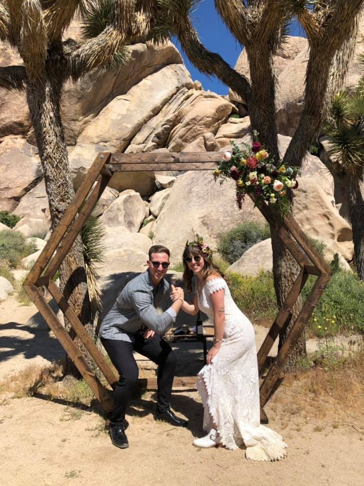 Diana and her brother in front of a chuppah after her Jewish elopement.