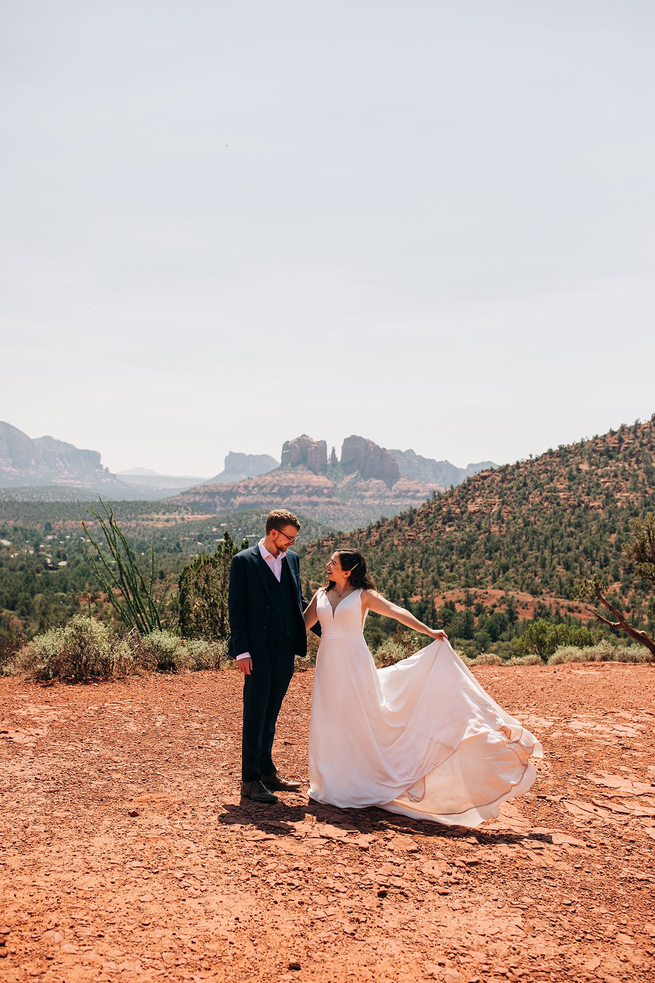 Steph shows off her amazing dress against the Sedona skyline while her new husband, Matt, gets close