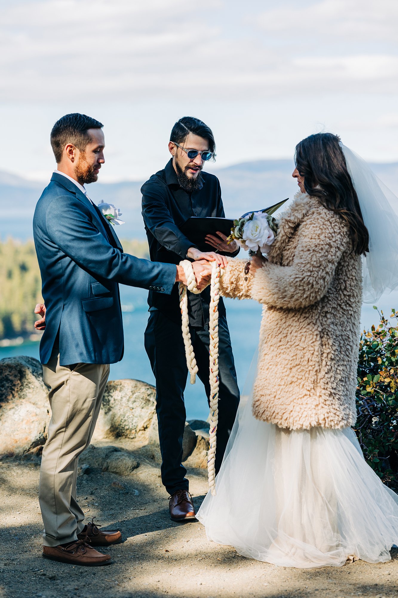 Caitlin and Keith enjoy their Tahoe wedding as officiant Isiah performs as handfasting.