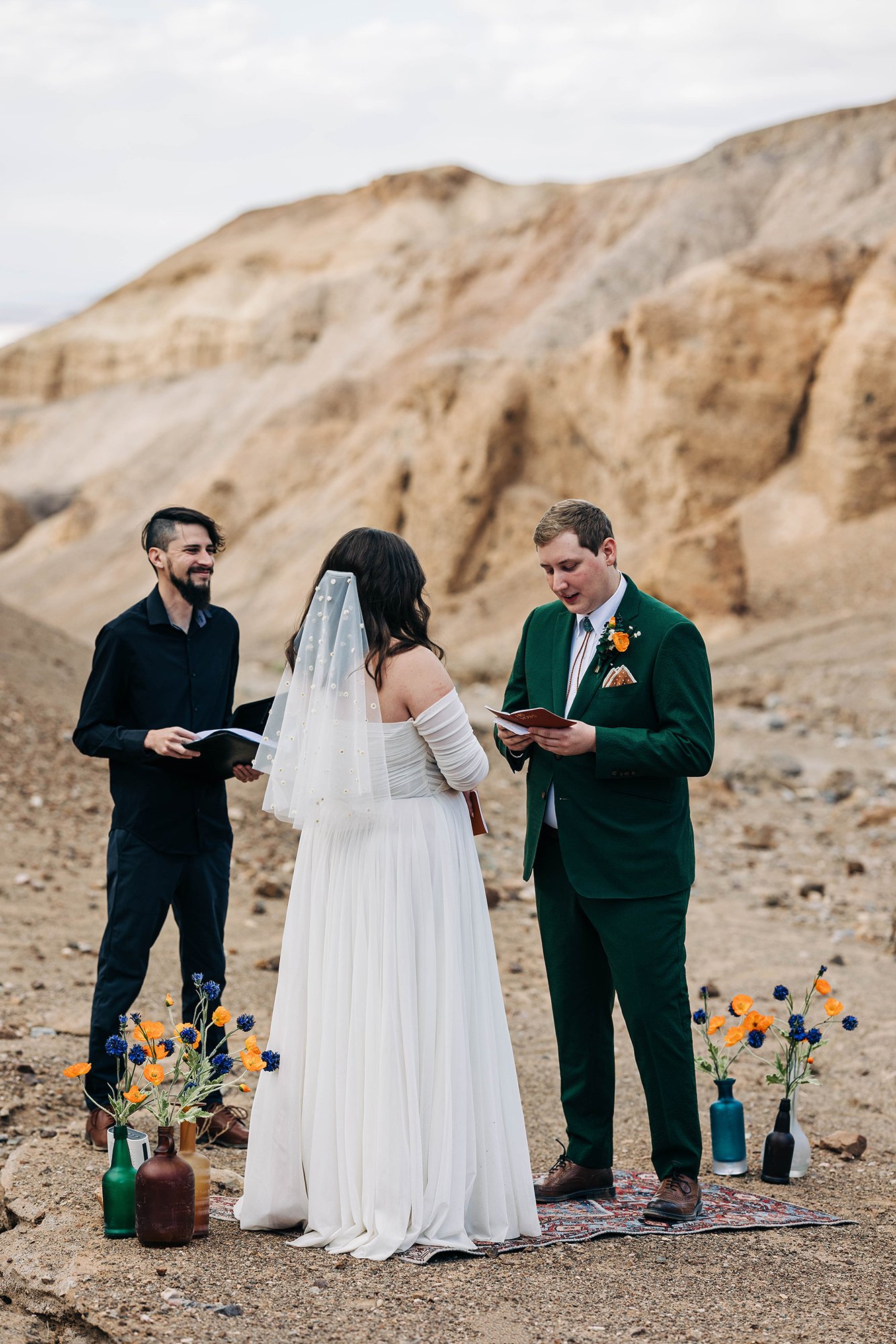 A groom reads his vows to his bride on their wedding day in Death Valley National Park.