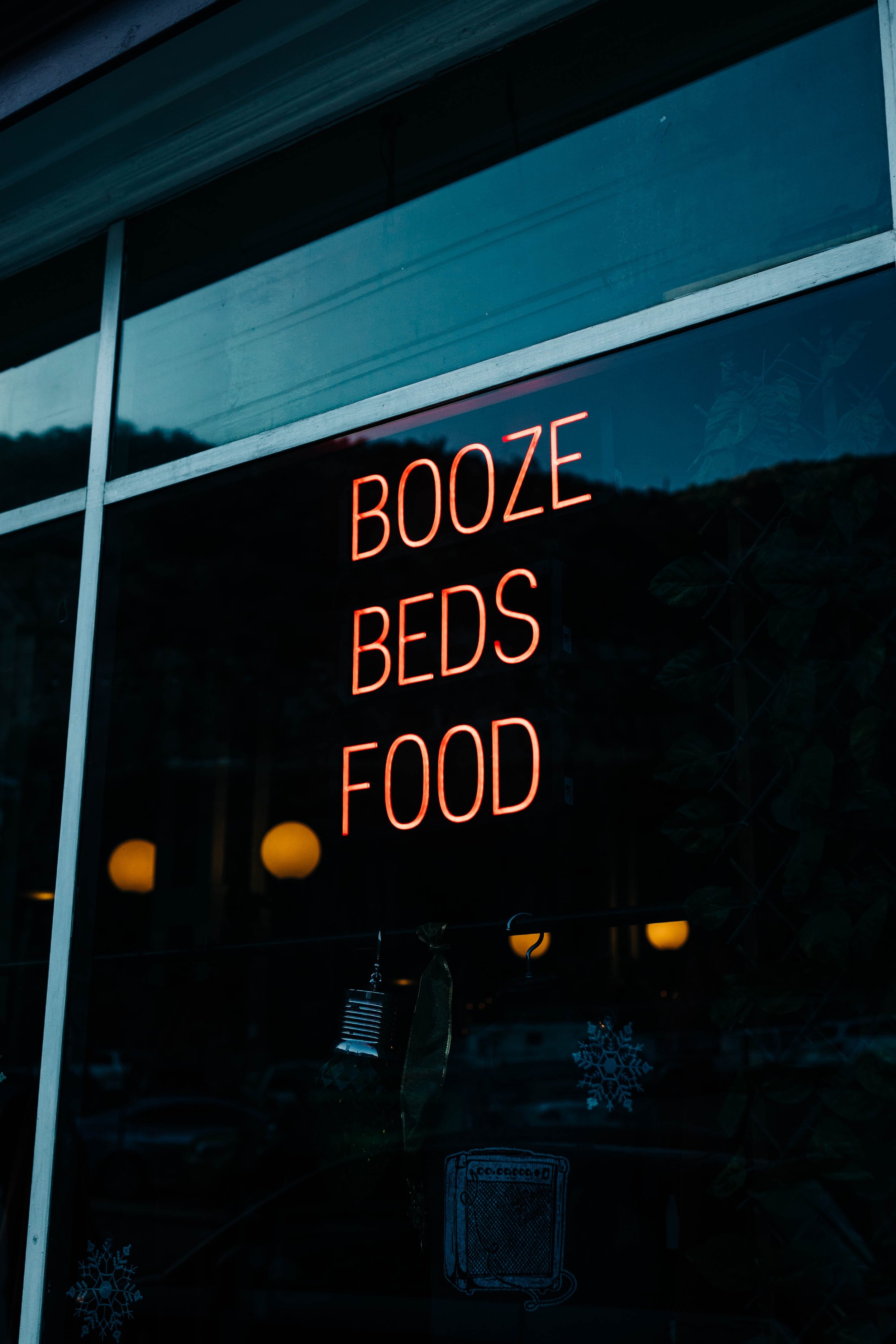 A sign that reads "Booze Beds Food" in Bisbee, Arizona.