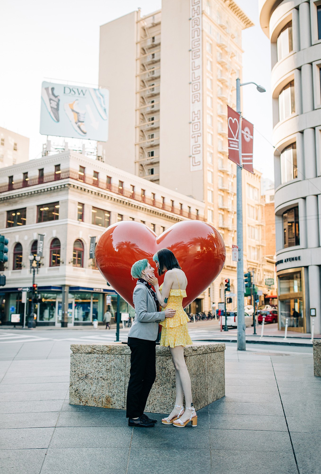 An and Sam pose in front of a heart sculpture in Union Square, San Francisco.