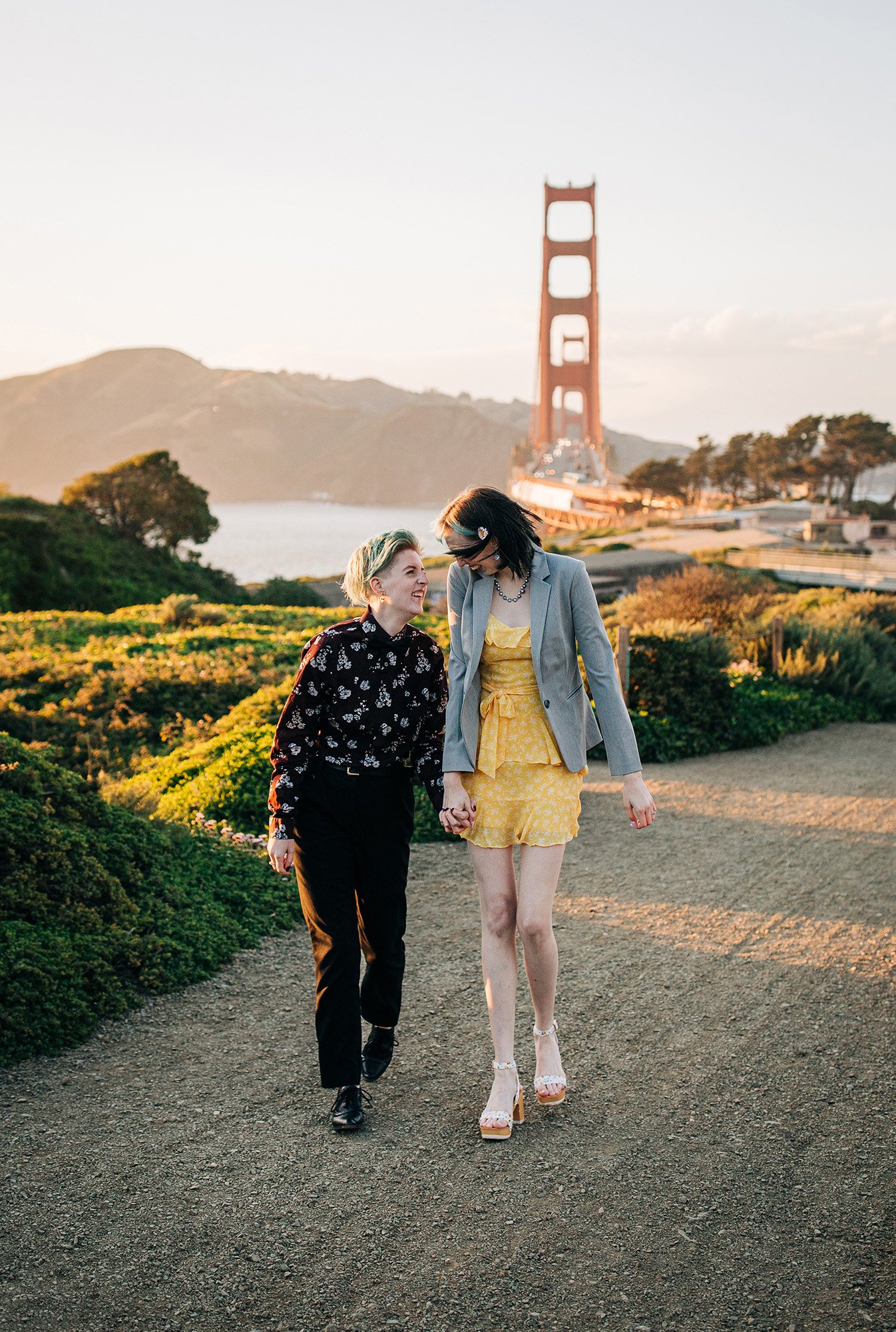 An and Sam walk together in front of the Golden Gate Bridge in San Francisco.