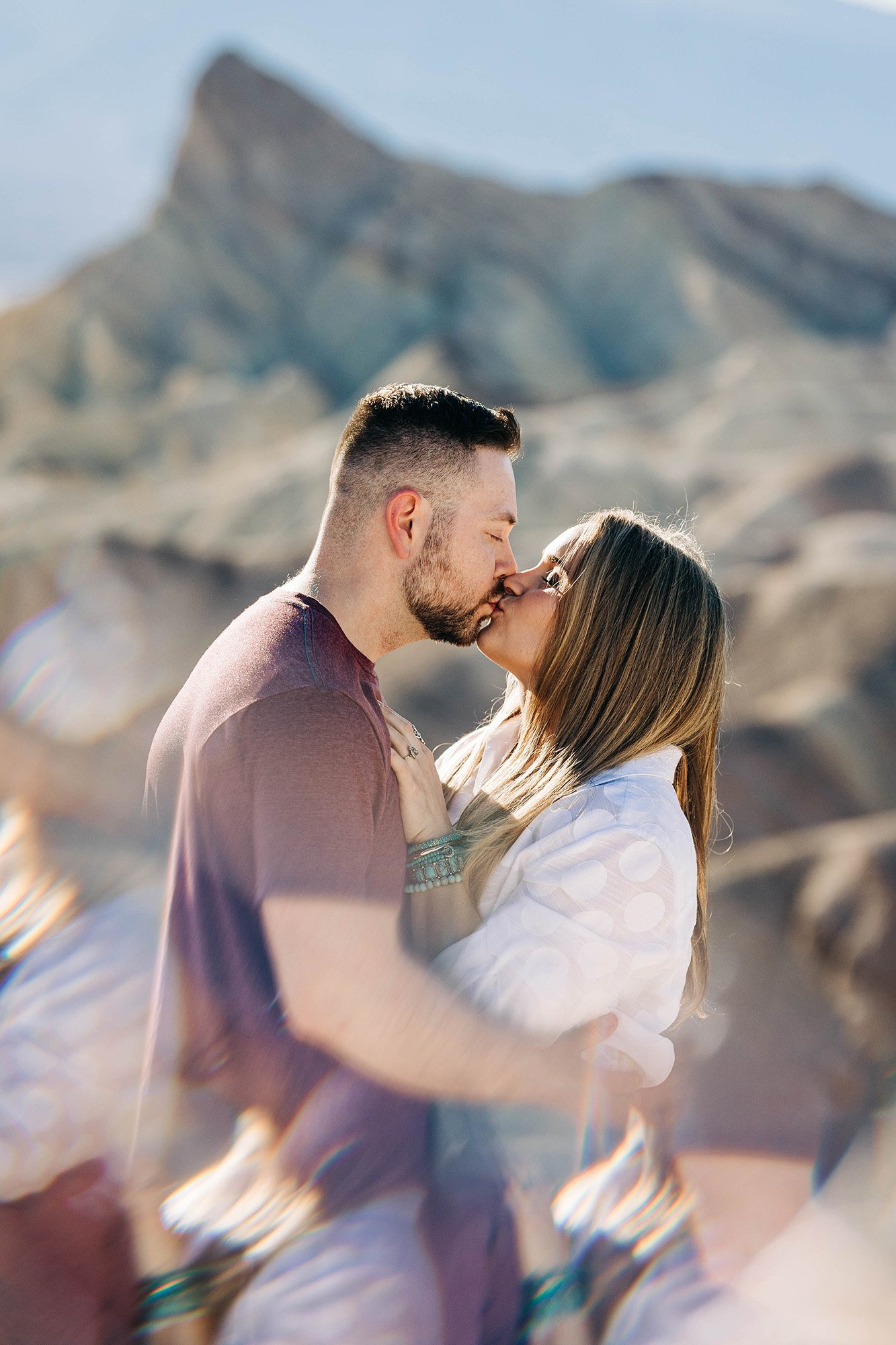 Aly and Alex kiss in Death Valley National Park.