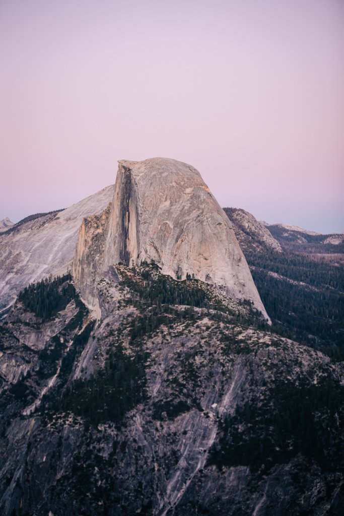 Pink and purple skies during a sunset at Half Dome in Yosemite.