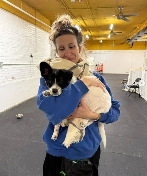 Trainer holding a puppy during a puppy training class in Chicago.