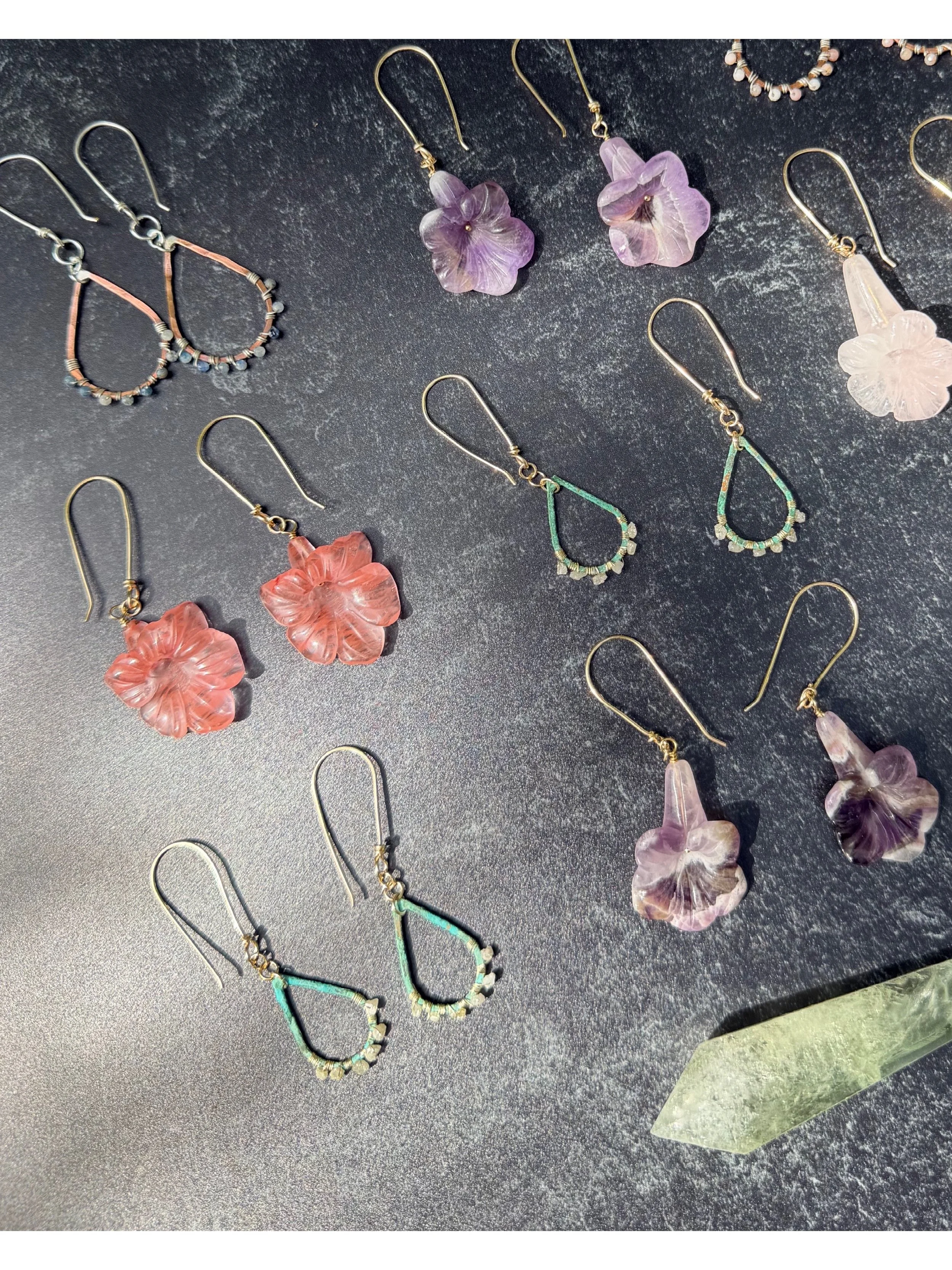 New work at @juliemillerpottery: Carved gemstone floral earrings as well as some older designs I decided to resurrect- copper wrapped with raw grey diamonds, iolite, or pink Peruvian opal. ✨

You'll also find new necklaces featuring Michigan-mined co