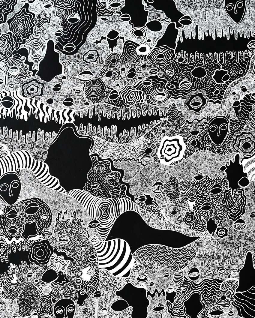 Black and white abstract doodle pattern with various face and eye shapes, swirling lines, and textured designs.
