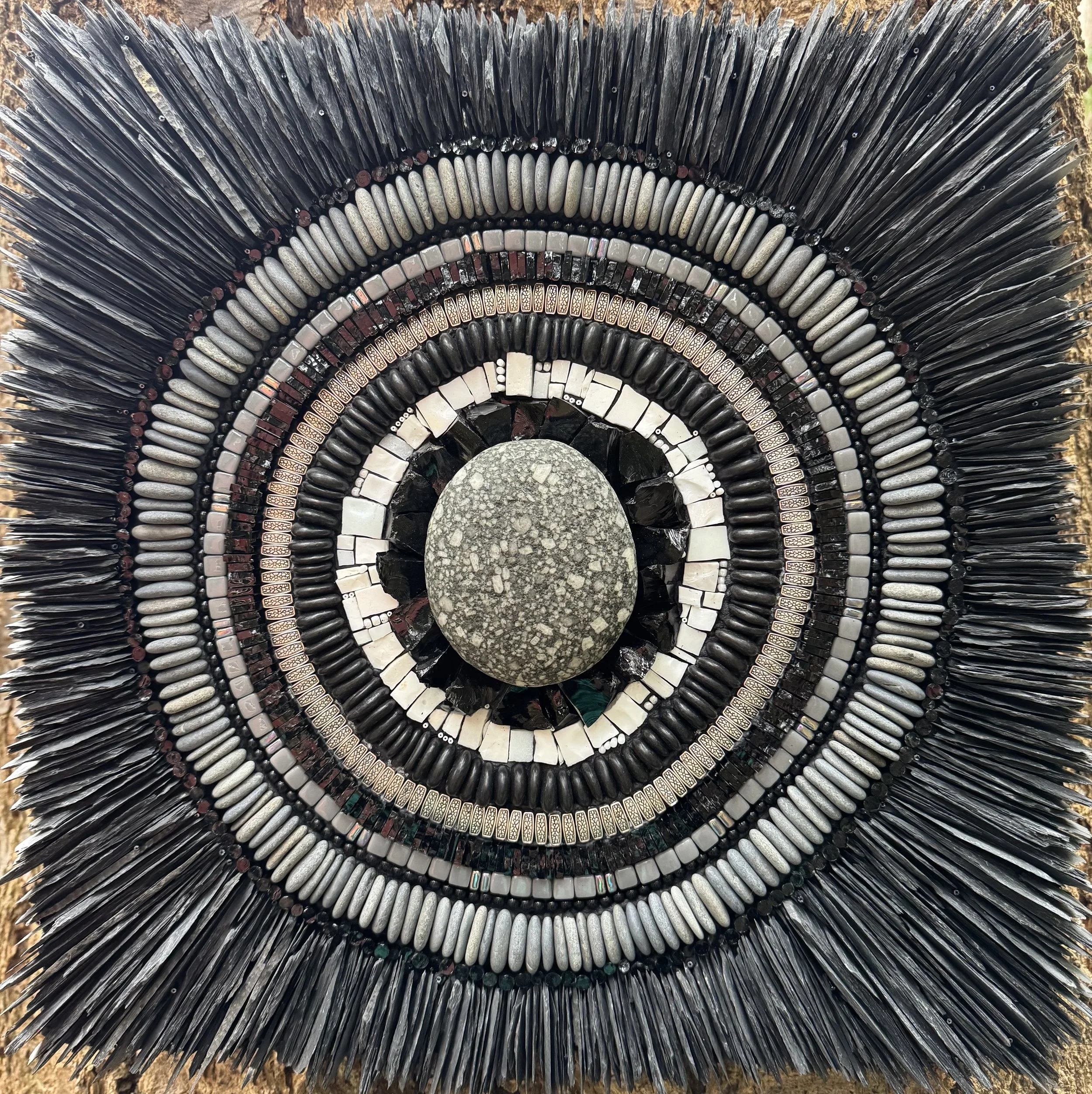 "Perfect Porphyry" - Central cobble of the igneous rock, porphyritic andesite brought to the shores of North Beach, Port Townsend, during the last ice age. Includes slate, beach pebbles, obsidian, glass beads, tiles and rods, metal beads, black river