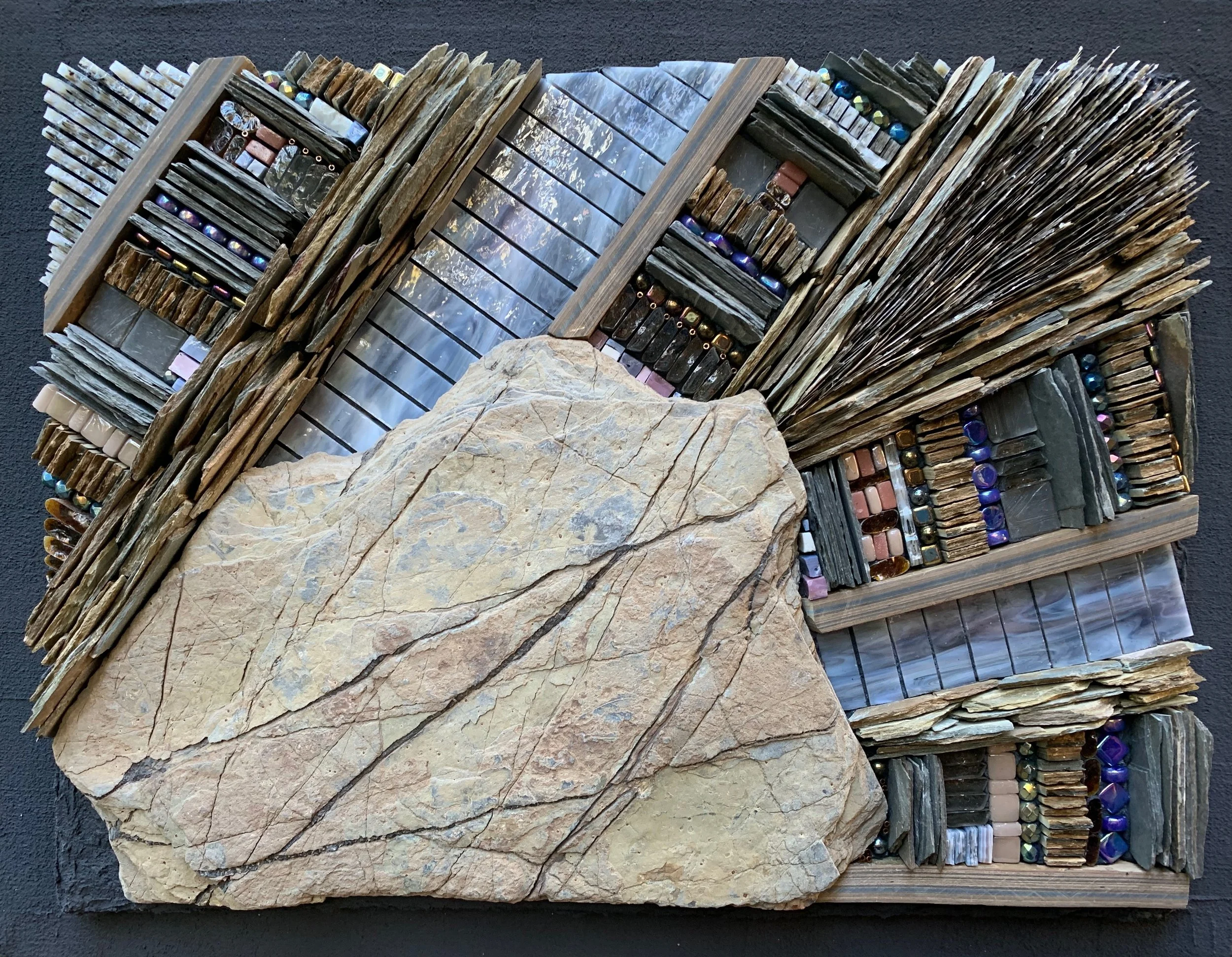 "Alaskan Argillite" - Sample of heavily veined argillite (mudstone) from Alaska. Various types of slate, mica, stained glass, glass beads, tiles, and rods, beach glass and smalti. 15"x13" On Wediboard in tinted thinset. NFS