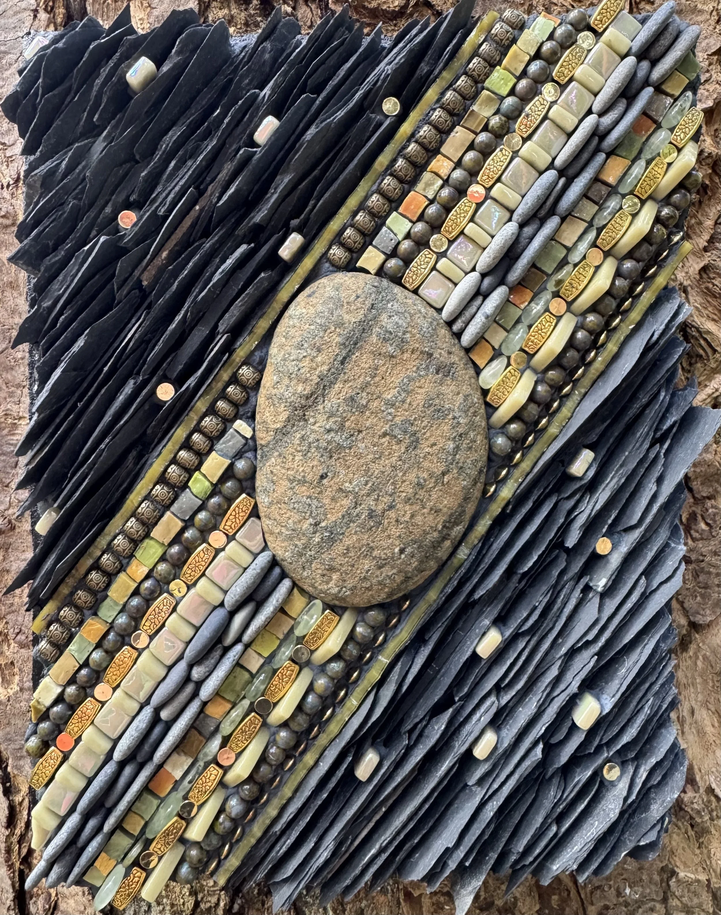 "Sensational Serpentinite" - Cobble of serpentinized peridotite (a piece of the ocean floor that has been hydrothermally altered). Includes beach pebbles, glass beads and tiles, brass beads, Smalti, stained glass, prehnite beads and slate. On Wedi bo