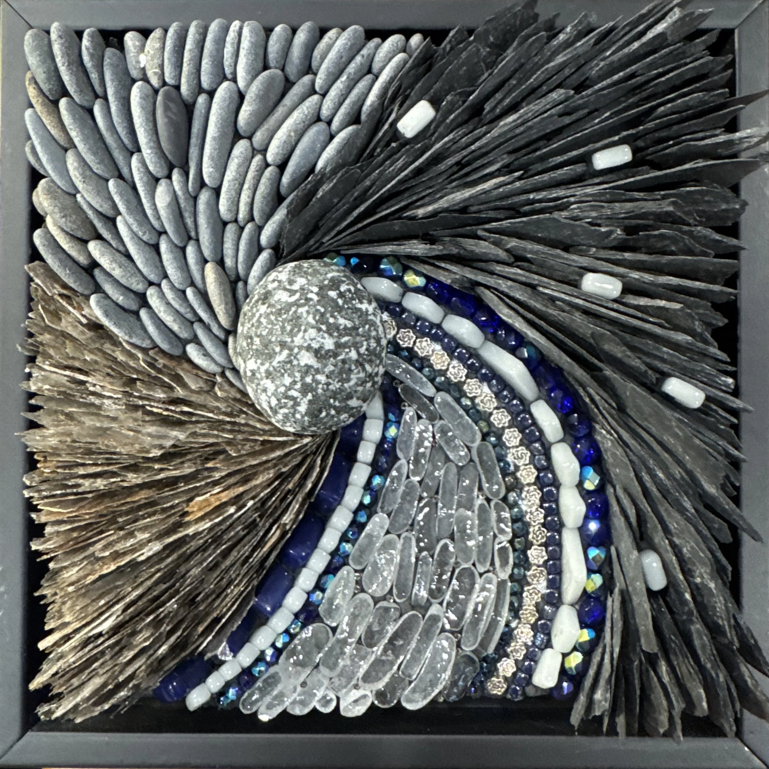 "Whorl in Time" - Central pebble of granite. Slate, beach glass, mica, beach pebbles, glass tiles and beads, metal beads. 7.5" x 7.5". Available.