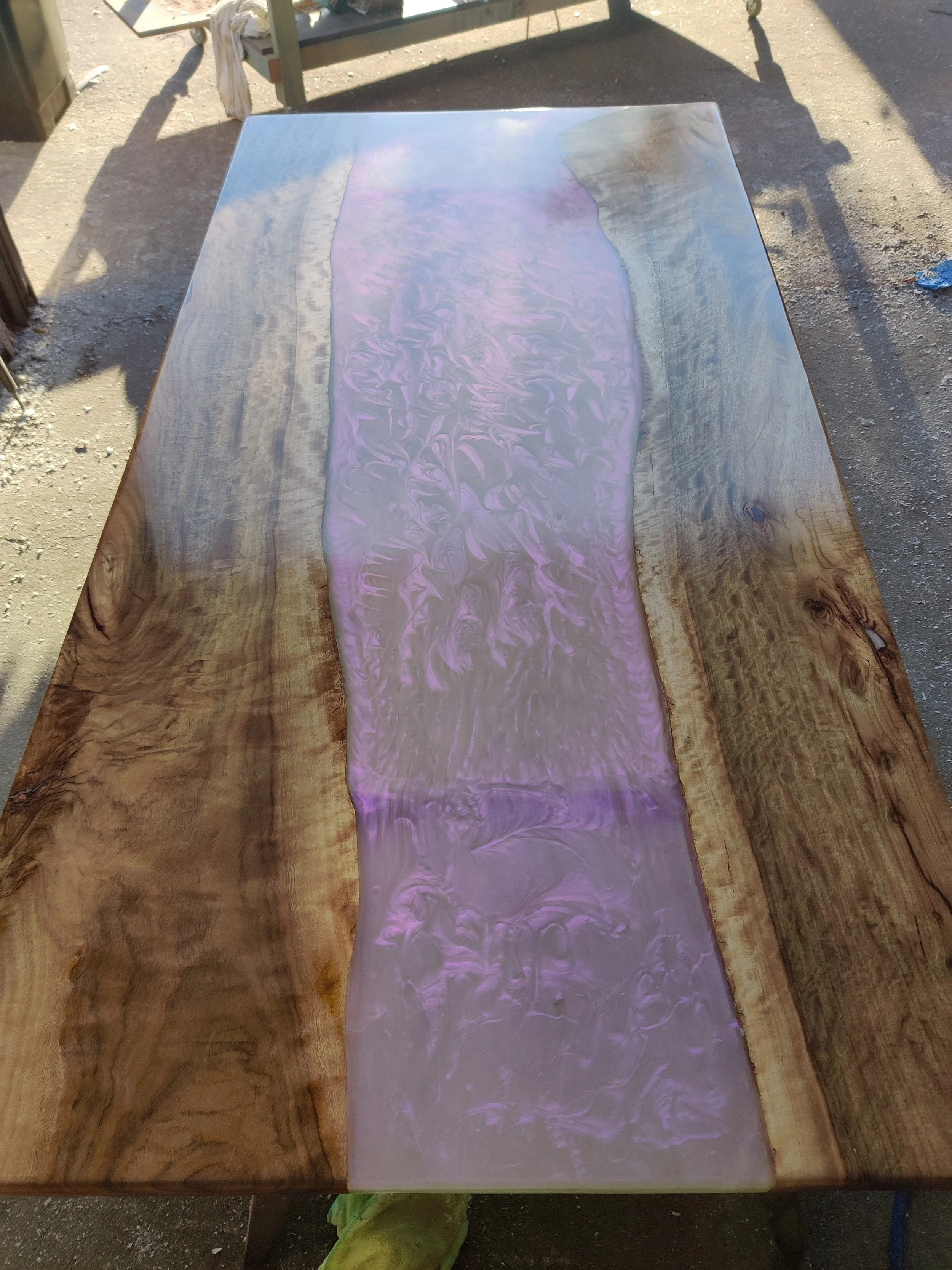 Wooden table with a purple resin river design.