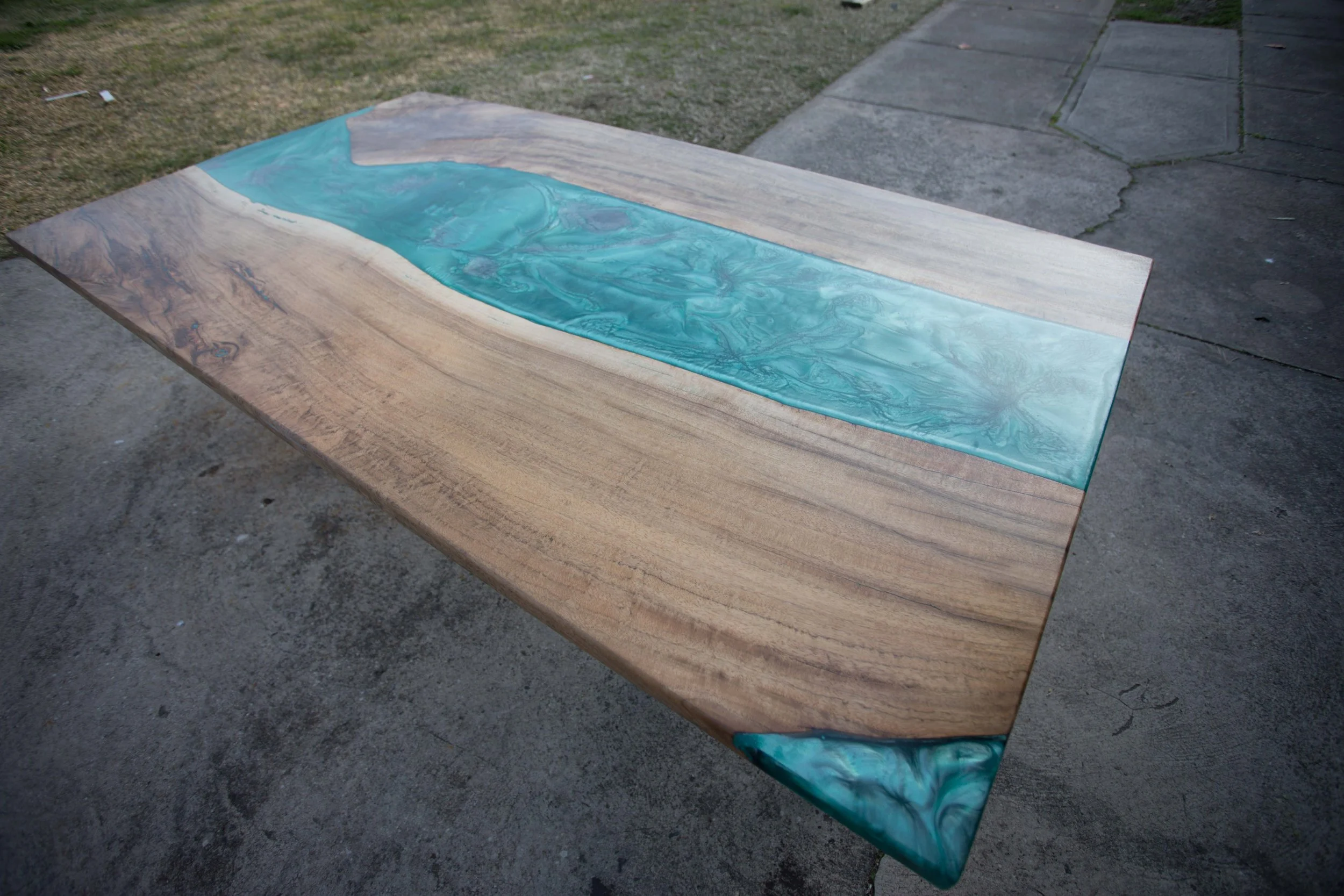 Wooden table with turquoise resin river design