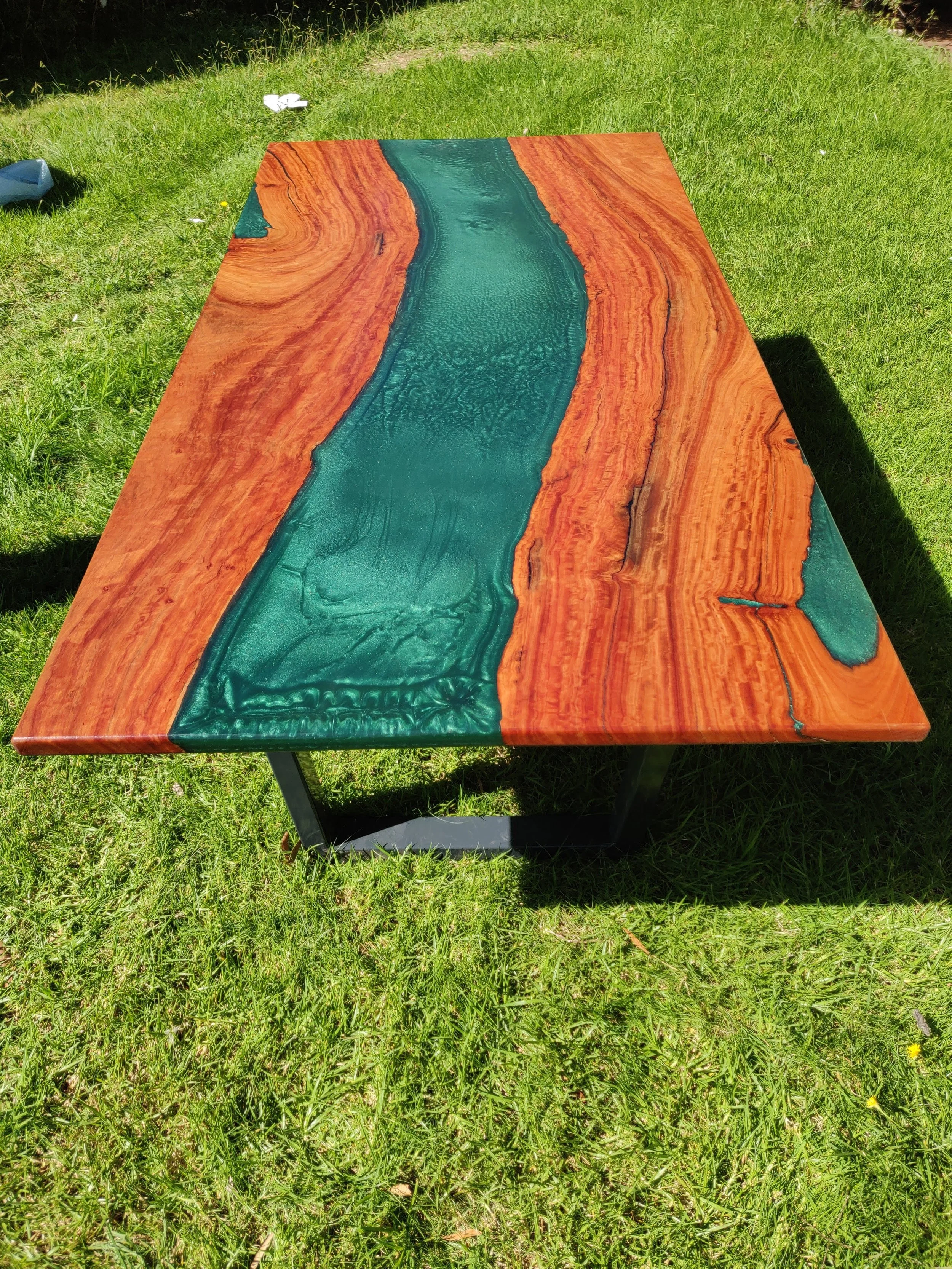 River table with an emerald epoxy and bright red box timber