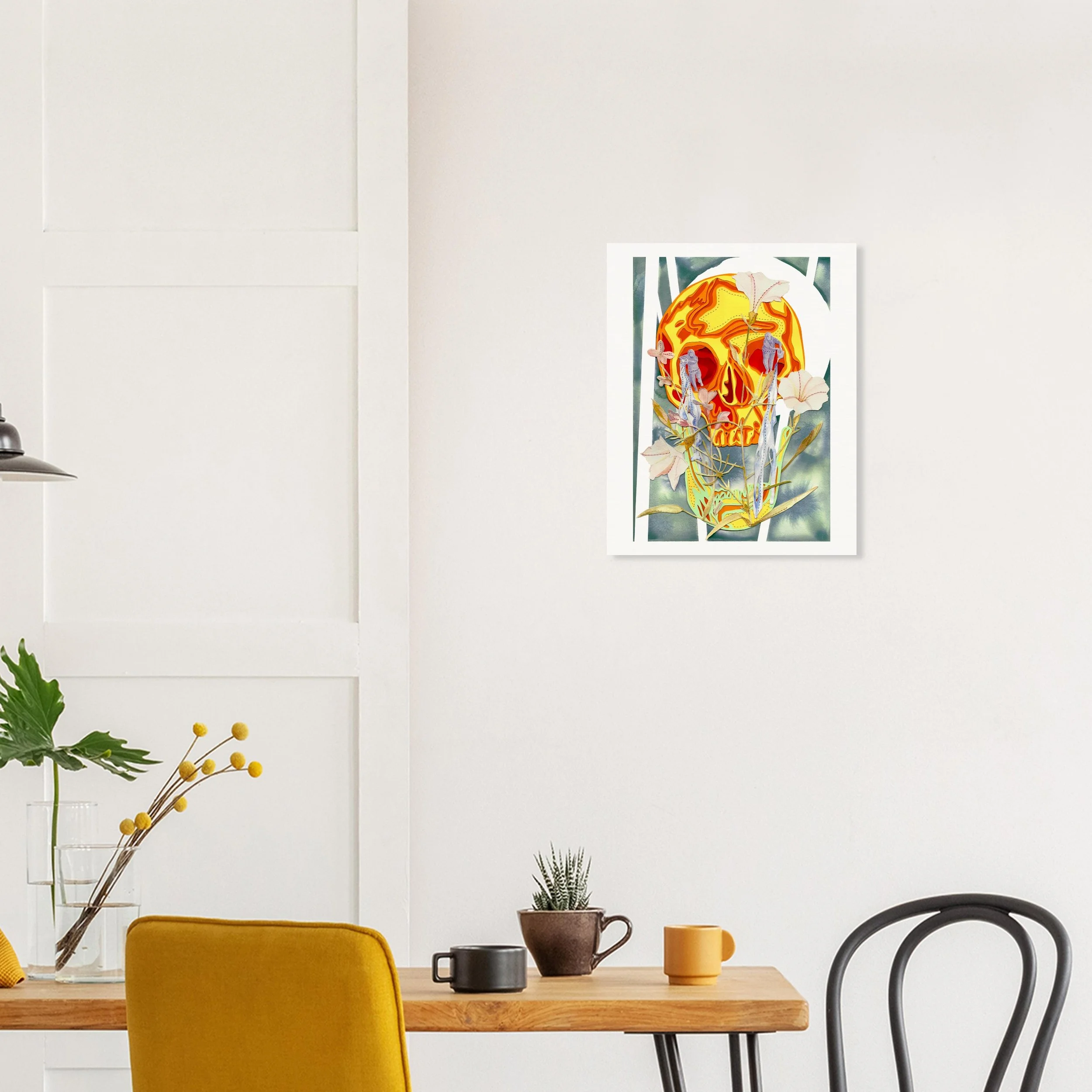 A contemporary dining room with a wooden table, yellow upholstered chair, and black chair. On the wall, there is colorful artwork featuring a skull integrated with floral and abstract elements.