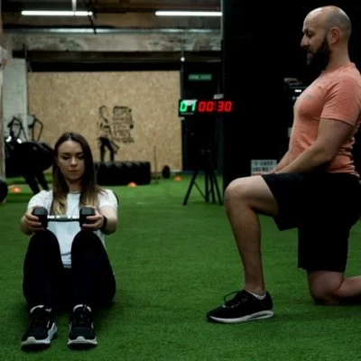 Gym owner giving exercise instruction