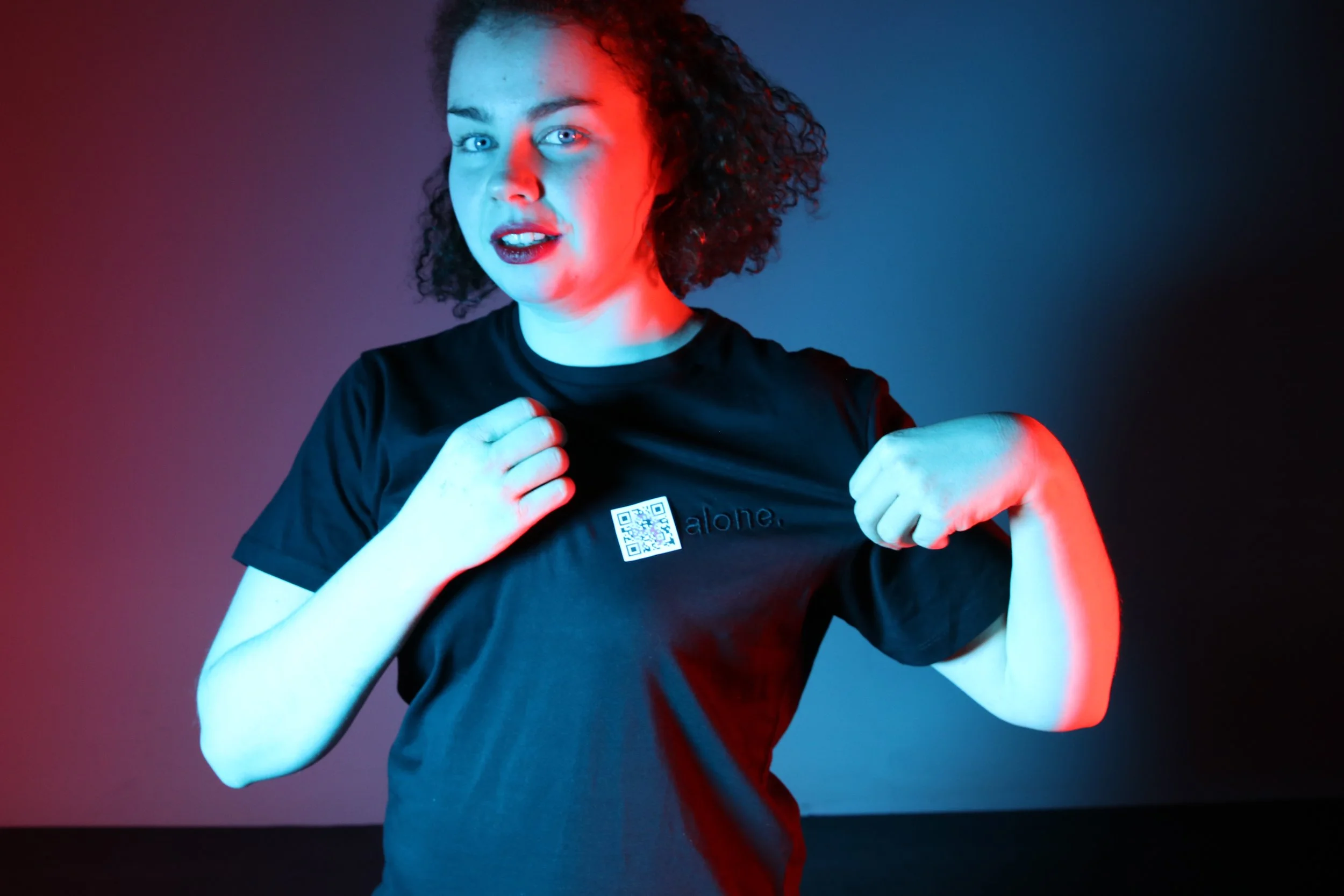 Girl wearing a tshirt with 'R' QR code logo. 