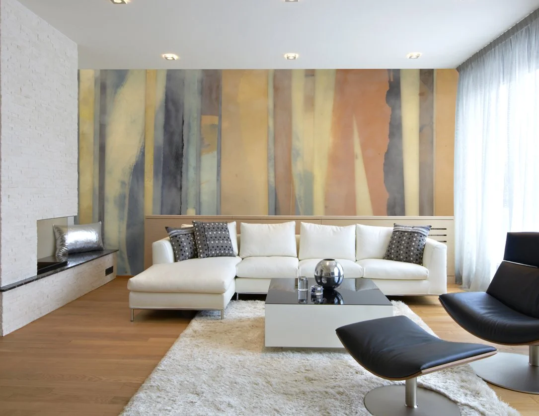 Modern living room with a white sectional sofa, black lounge chairs, a textured accent wall, and a hardwood floor.