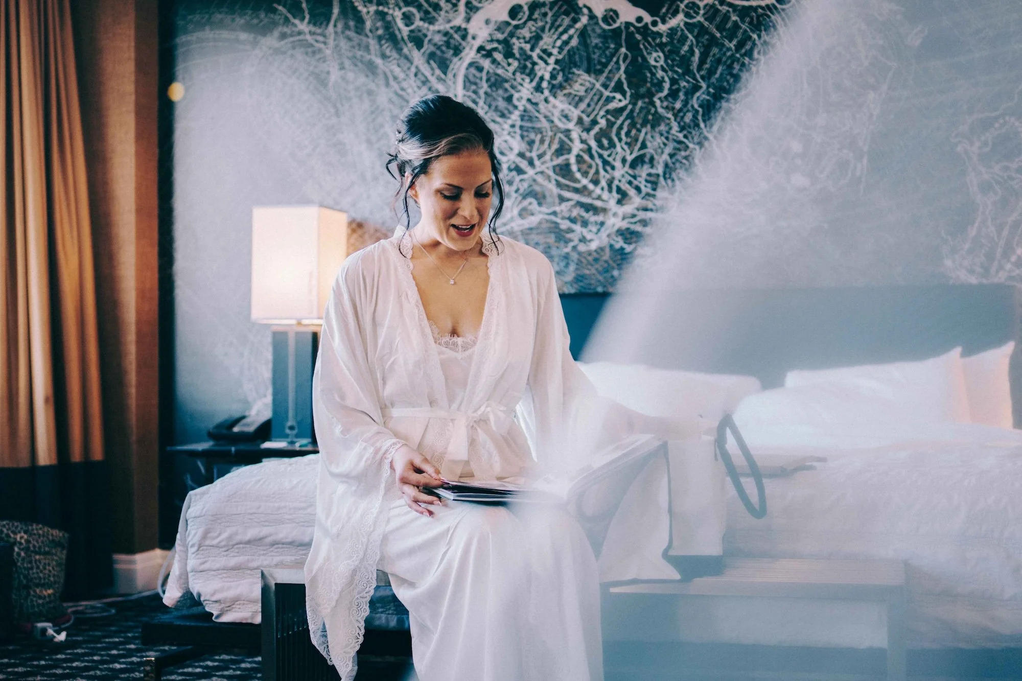 Cinematic capture of a bridal veil draped across a chair in soft natural light.