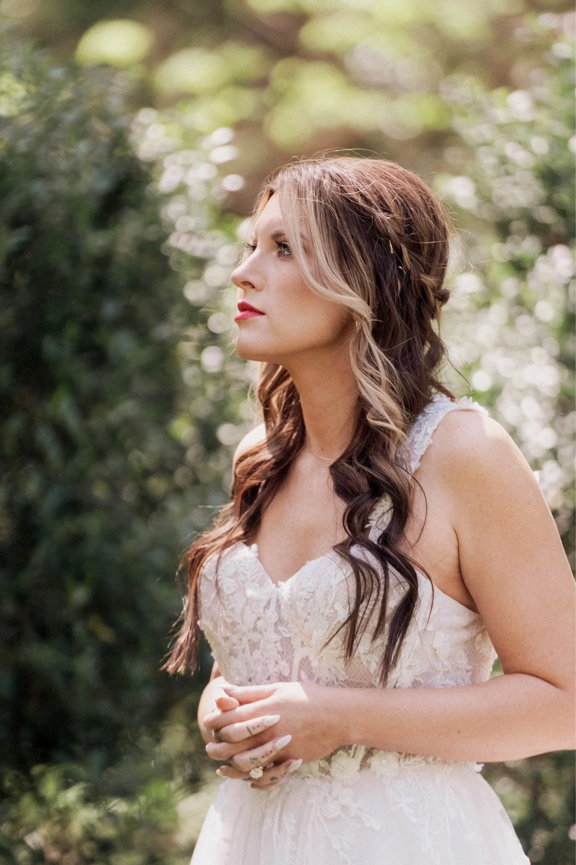 Close-up bridal portrait with soft curls and lace detail captured by Caz Isaiah