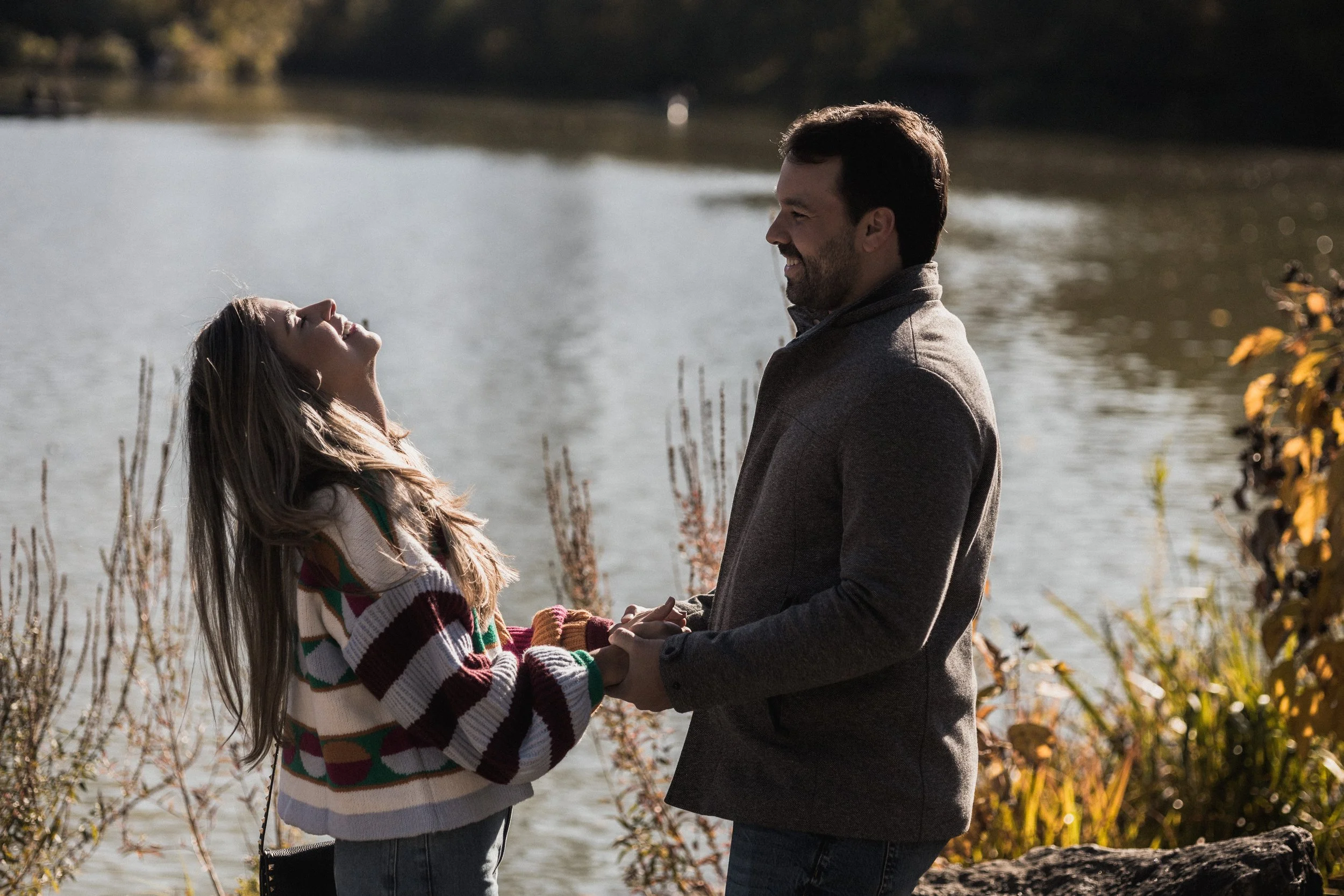 Autumn proposal at Top of the Rock — candid engagement photos with golden light over New York City.