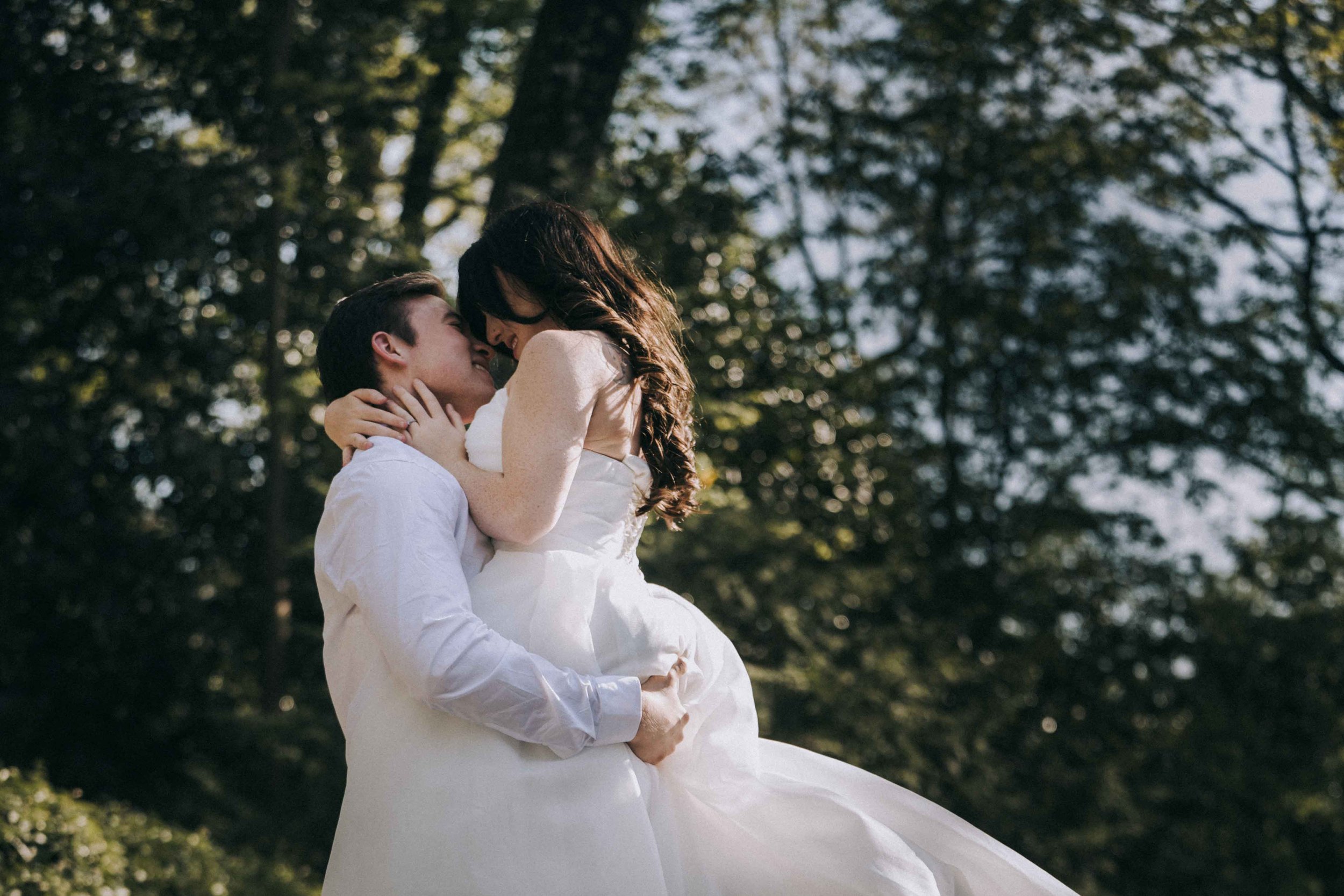 A woman in an embroidered gown stands near a window, light grazing her profile as Fragmented Memories couples photographer frames the still moment.