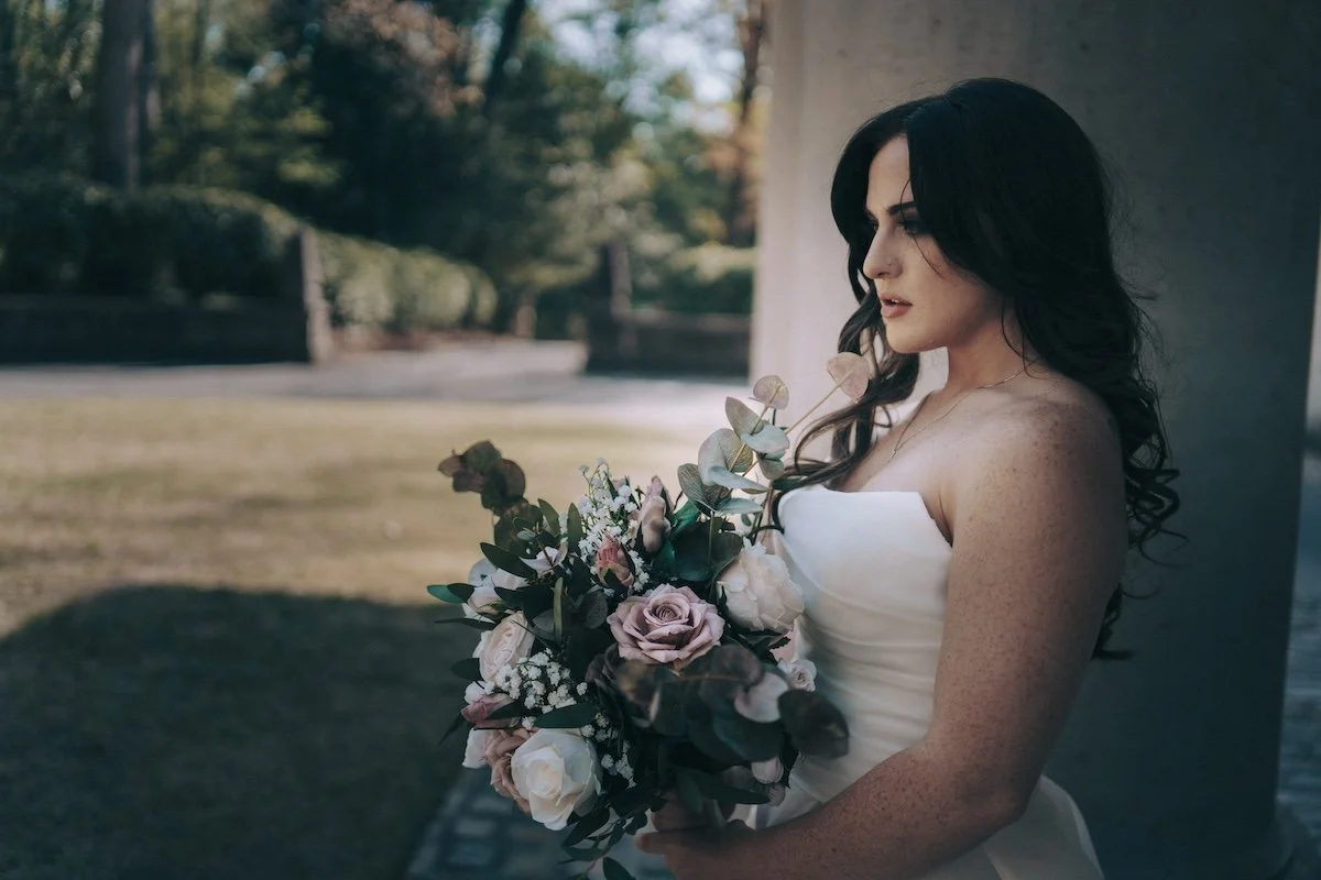 620 Loft & Garden Wedding Photographer — bride holding her bouquet close, blooms captured in timeless editorial style.