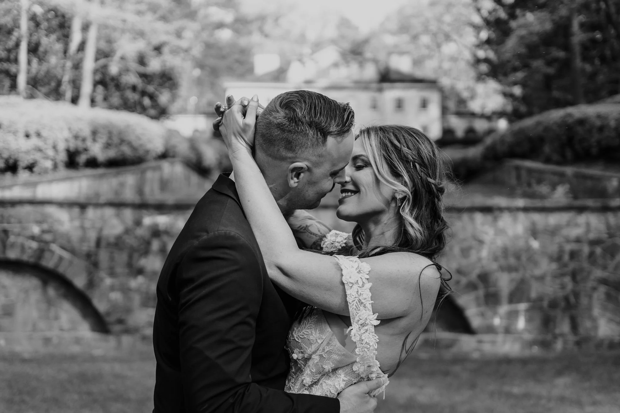 A couple holding each other closely, their embrace framed with quiet intimacy, captured by an Intimate Wedding Photographer.