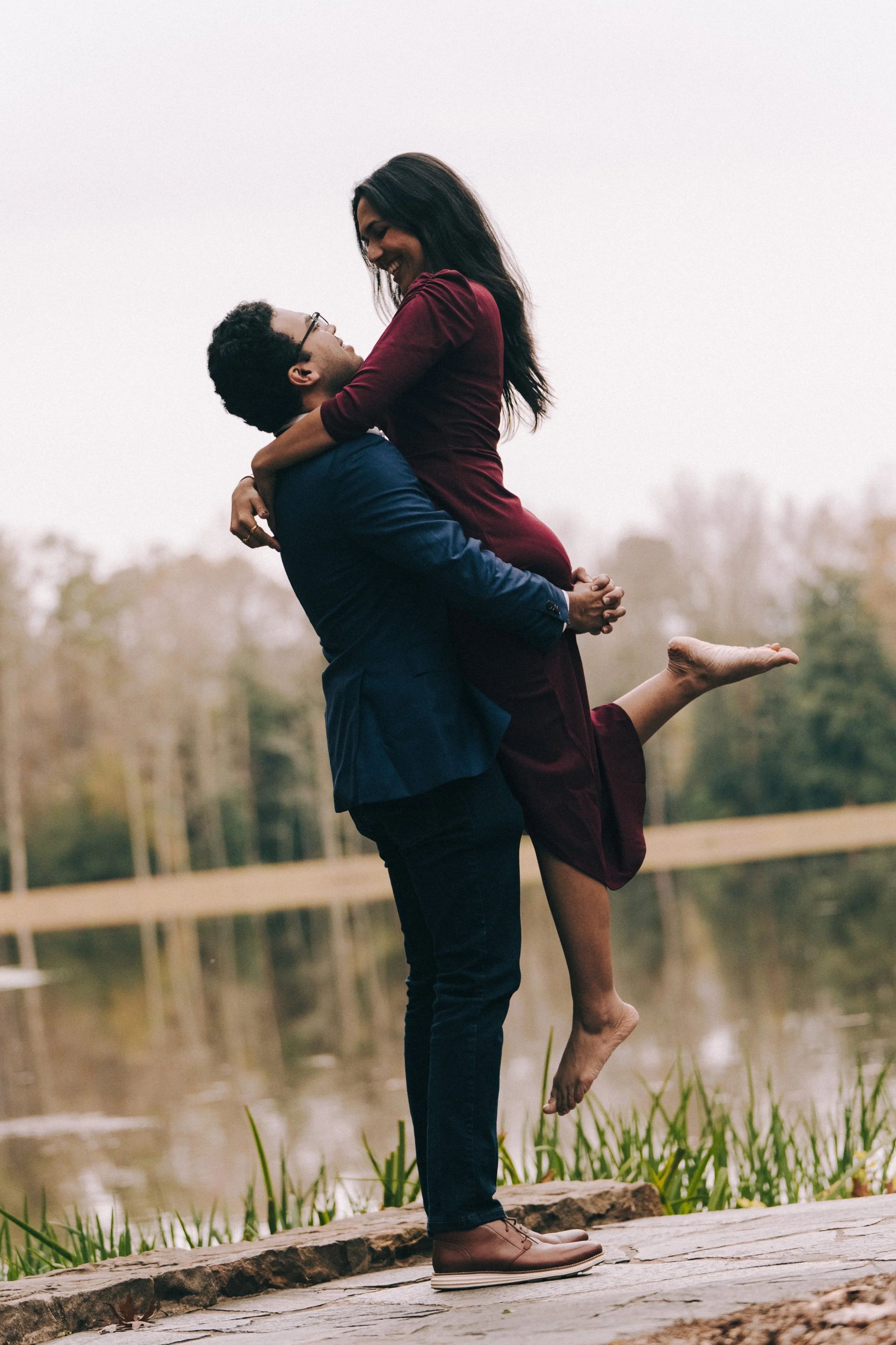 Romantic embrace at Top of the Rock — intimate engagement photo with sweeping New York views.