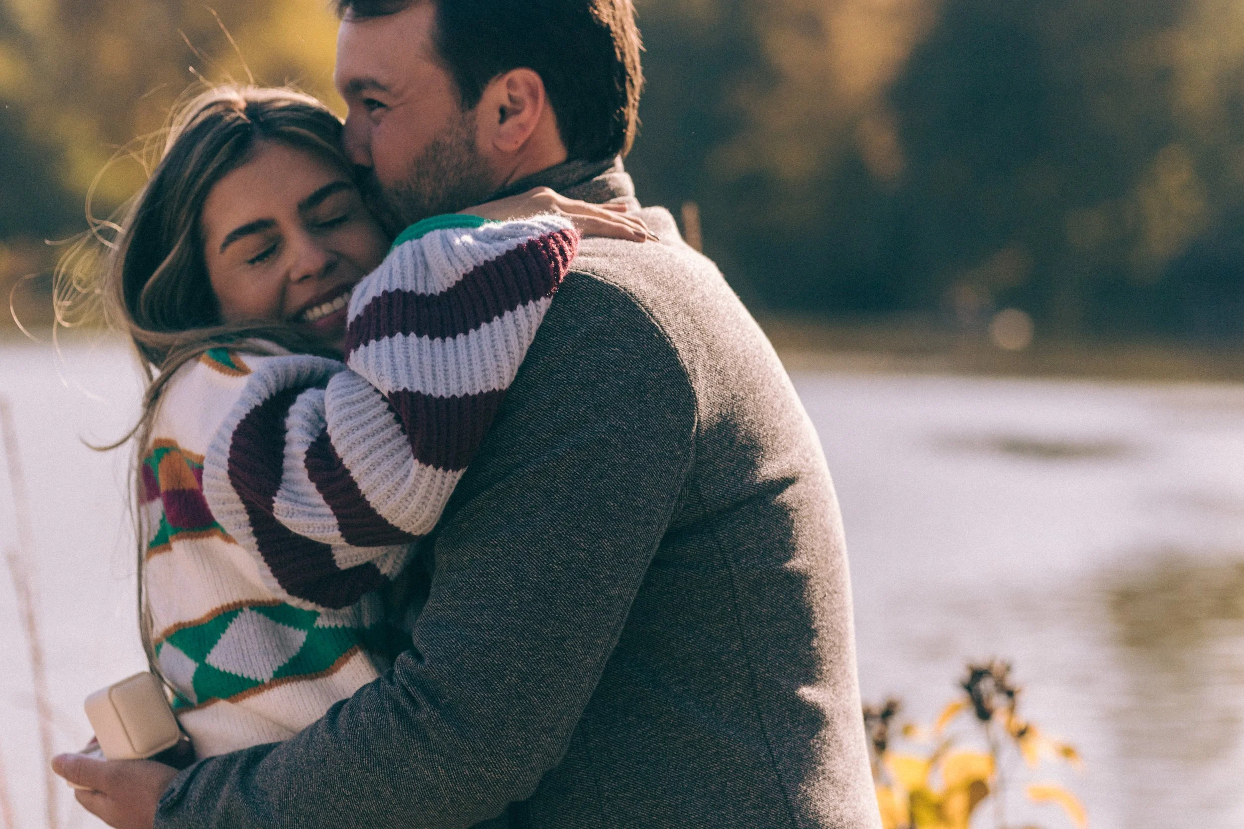 Couple embracing after their surprise proposal at Top of the Rock — emotional and elegant NYC engagement photography.