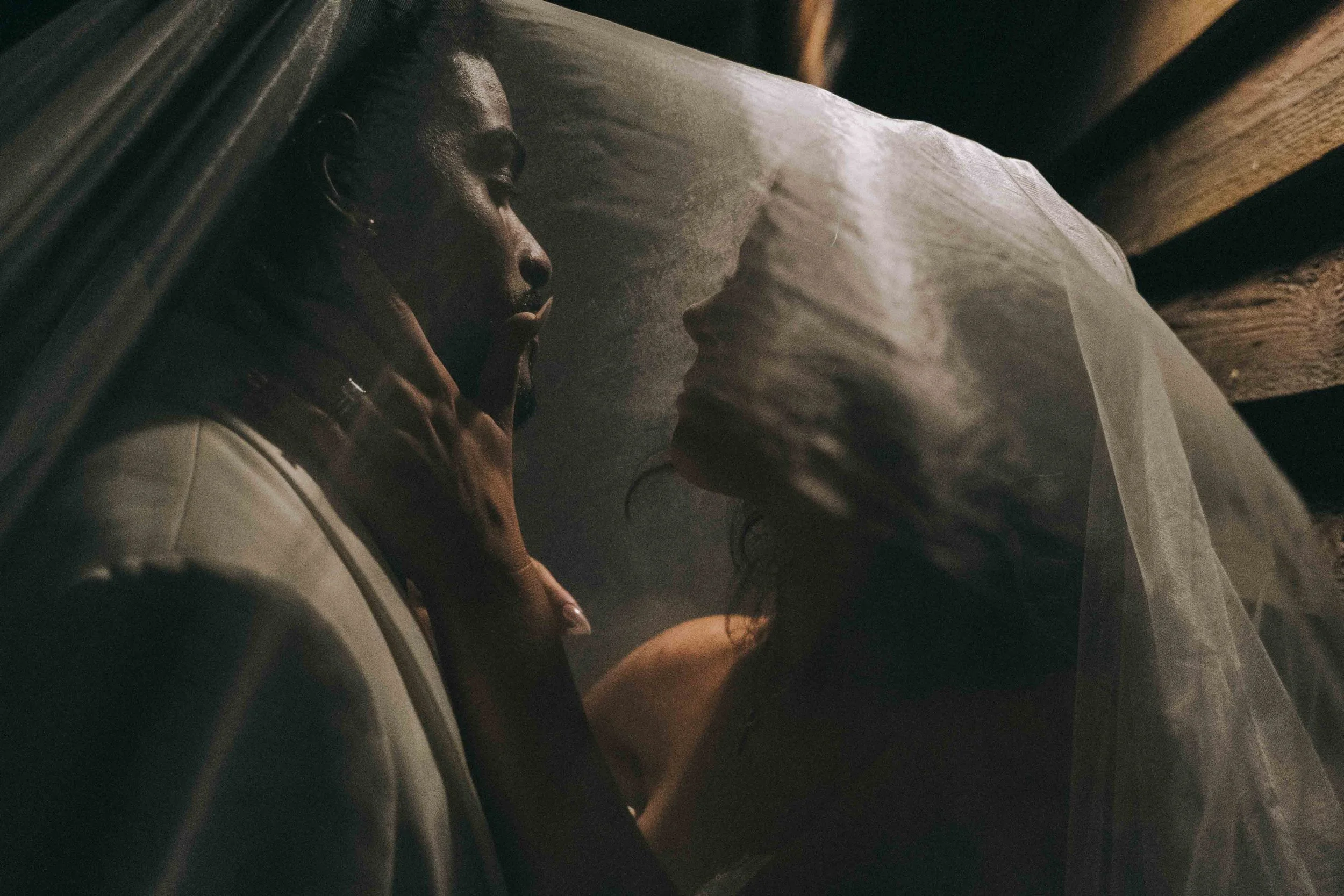 Bride and groom under veil illuminated by golden glow inspired by Belmond Hotel Cipriani Venice wedding style