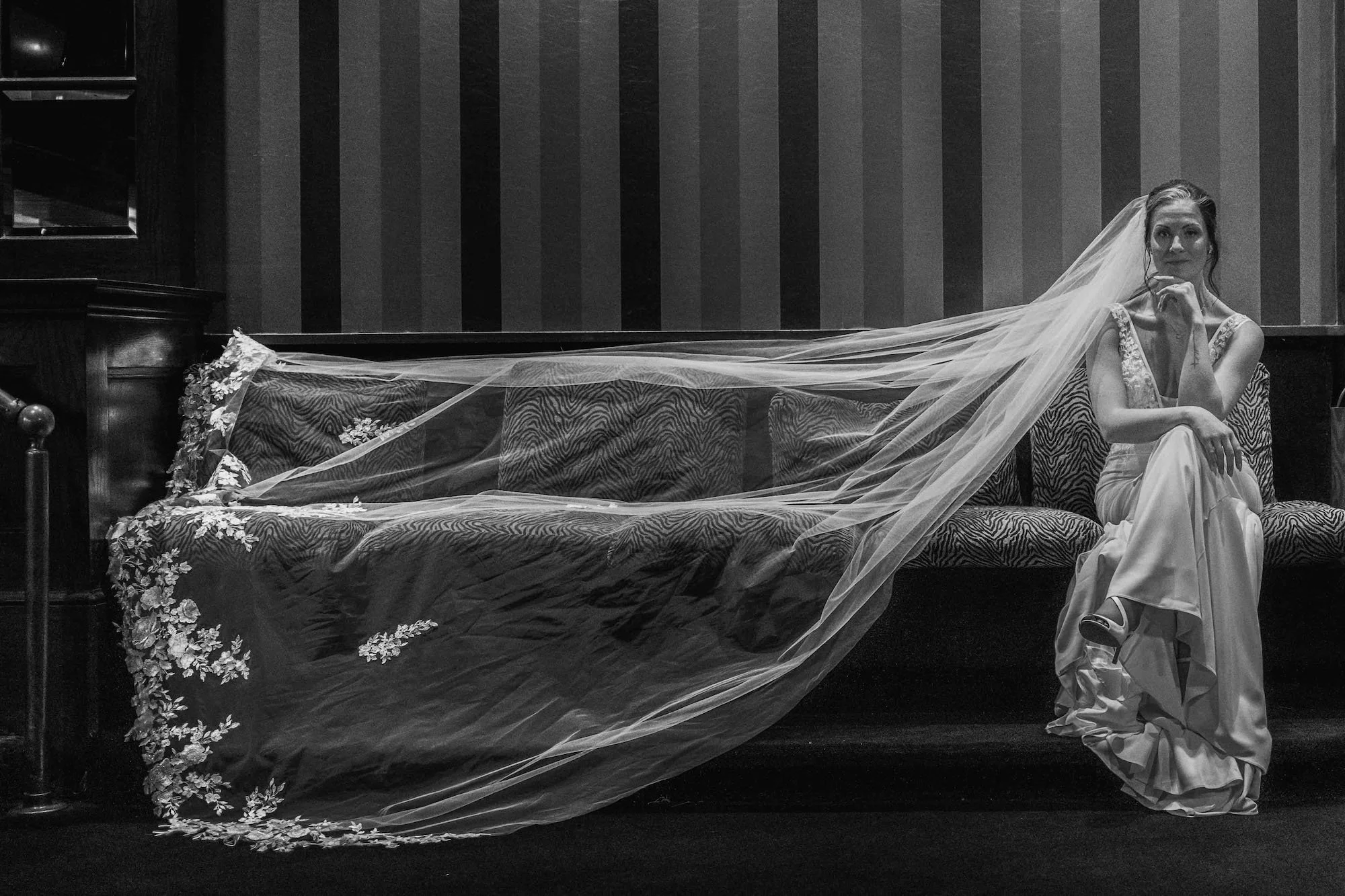 A flowing wedding dress caught mid-air in movement, captured with elegance and editorial style