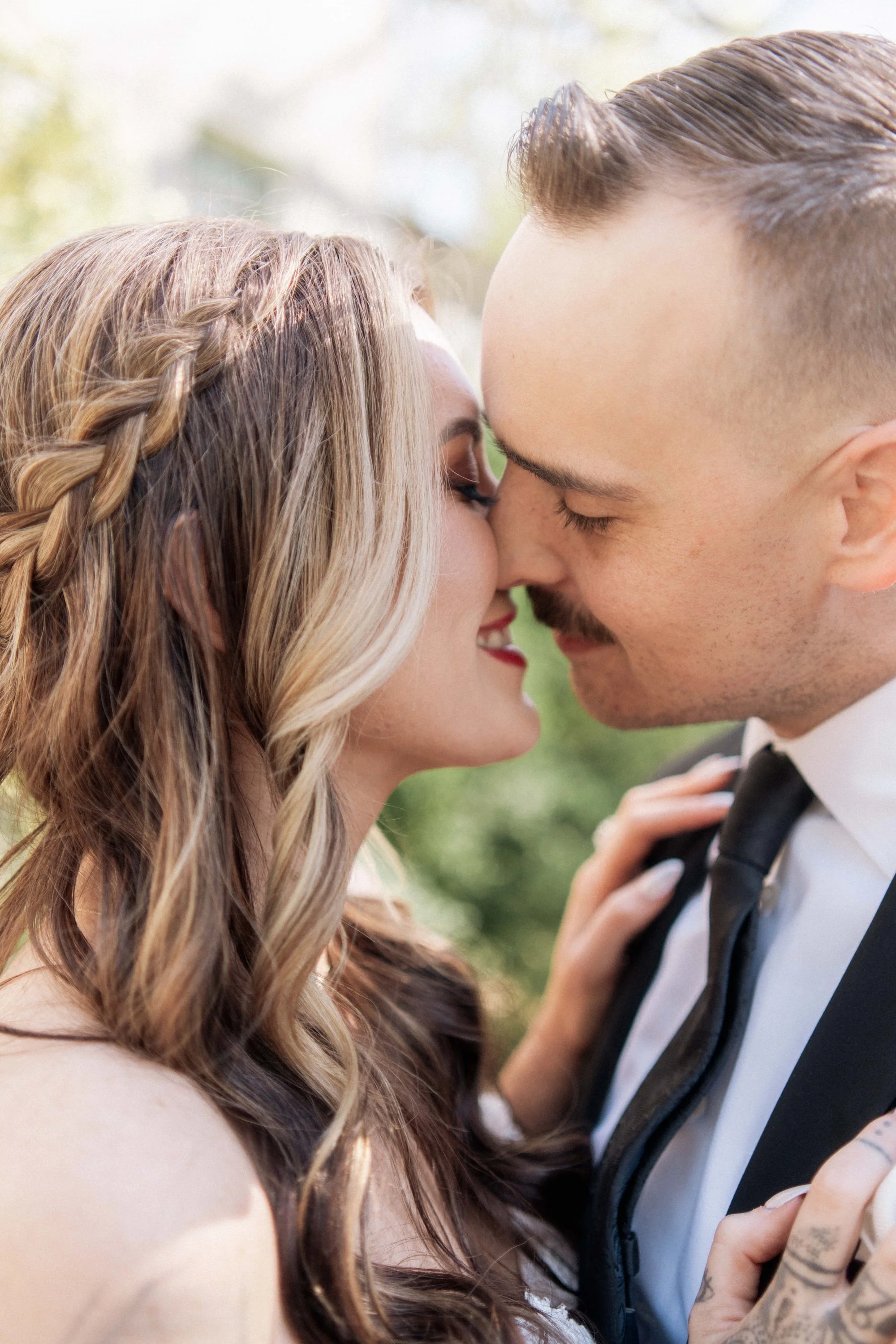 A couple forehead to forehead, framed in close embrace, cinematic tones by Bali wedding photographer Caz Isaiah.