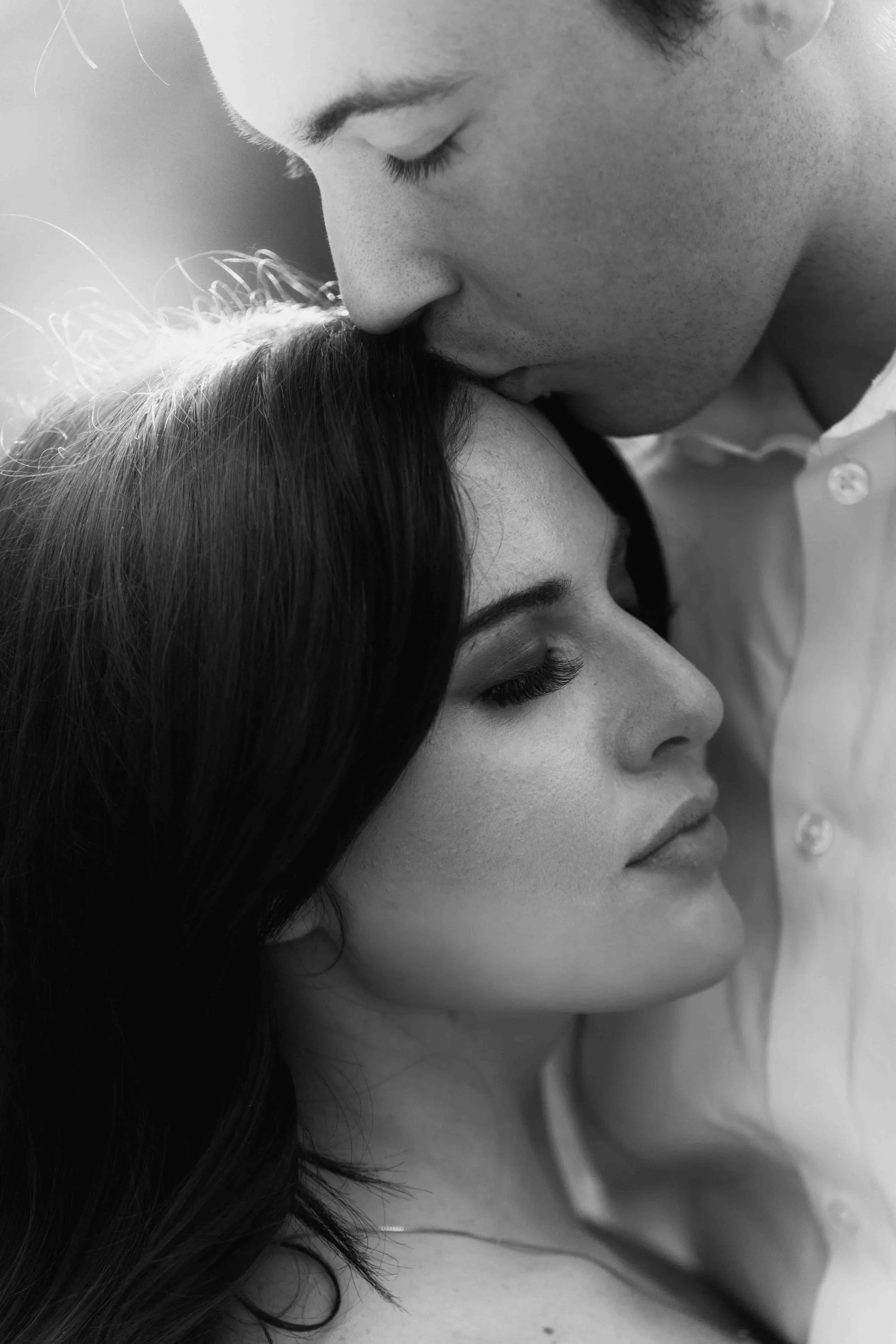 wedding couple's soft embrace and kiss during sunset