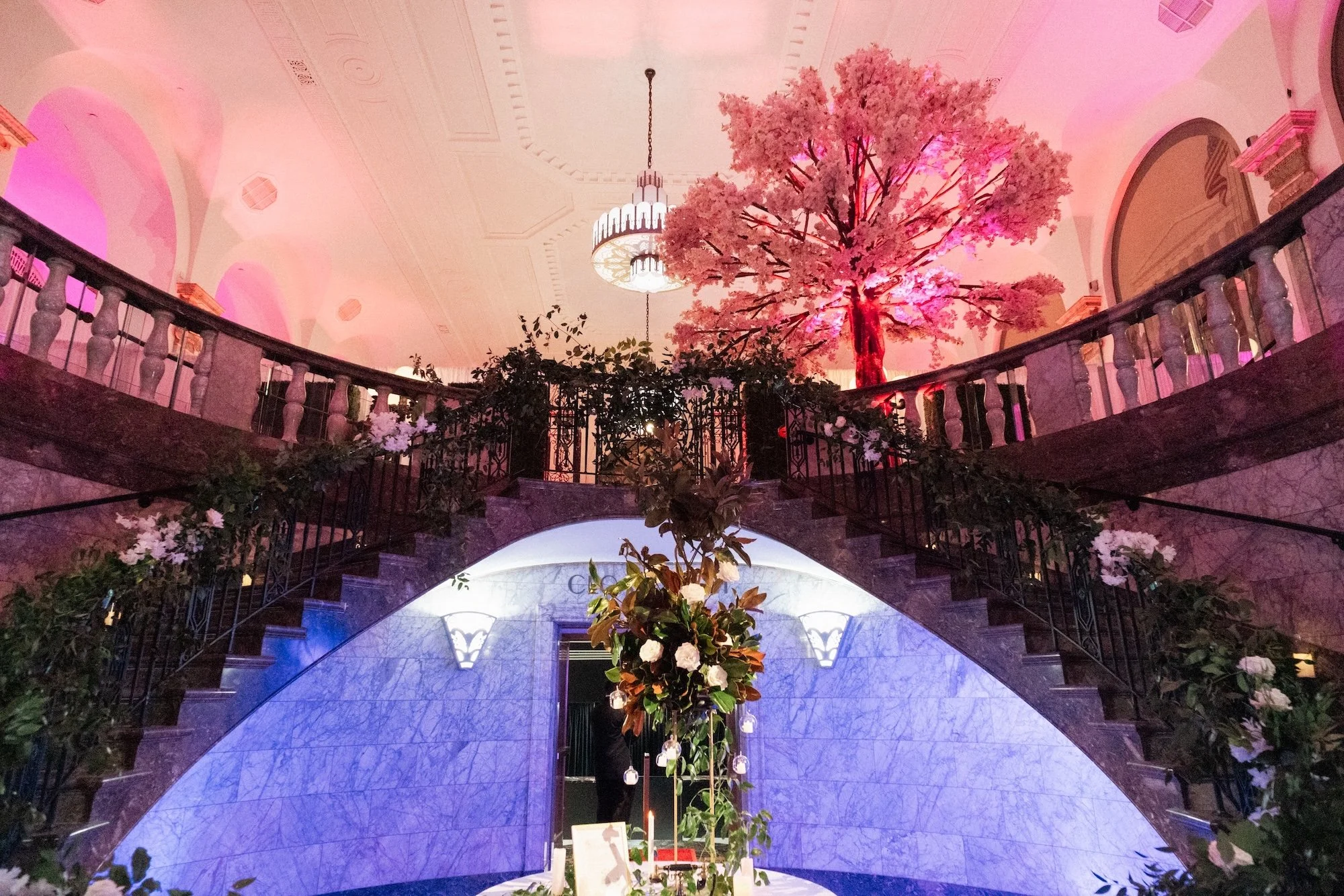 Dubai Wedding Photographer — luxury floral ceremony setup with dramatic uplighting on the grand staircase.