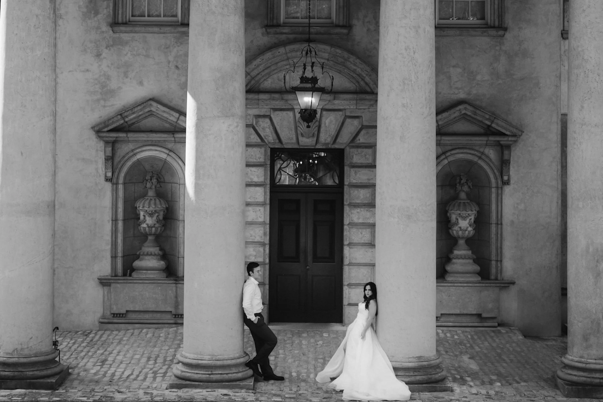 BW photo of wedding , massive columns