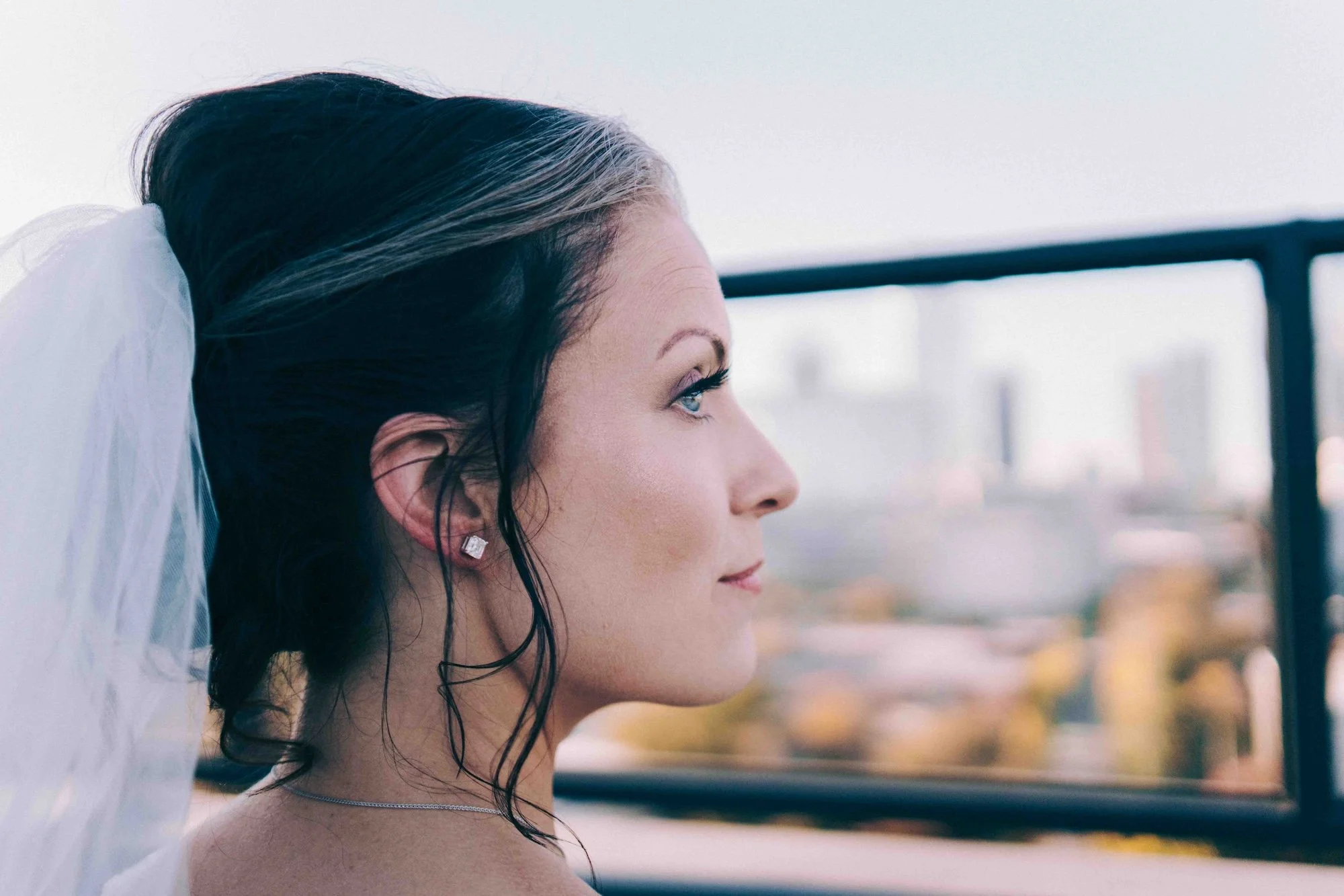 A portrait of a bride in profile, her hair gently swept back, a timeless editorial frame.